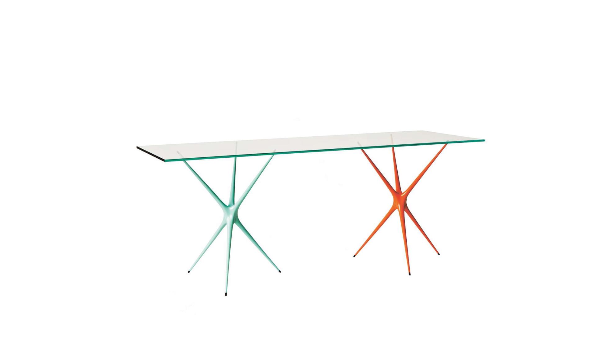 Stylish glass console table with geometric, turquoise and orange bases, perfect for enhancing modern interiors.