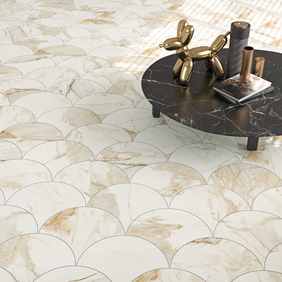 Elegant marble-effect tiles in a scallop pattern, paired with a modern black coffee table, showcasing 2019 tile trends.