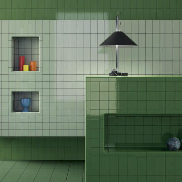 Vibrant green tiled interior featuring built-in shelves with colorful decor and a stylish lamp, showcasing modern design elements.