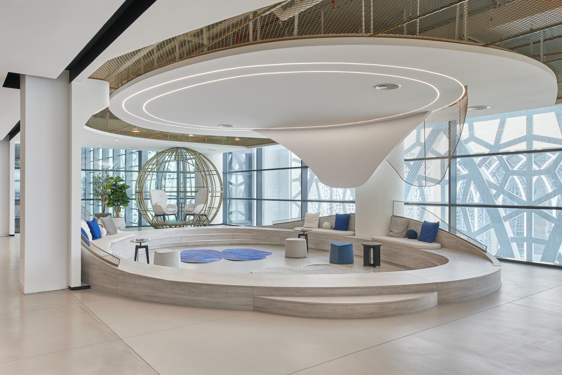 Vibrant co-working space in Sharjah's entrepreneurship center featuring modern seating, artistic design, and large windows.