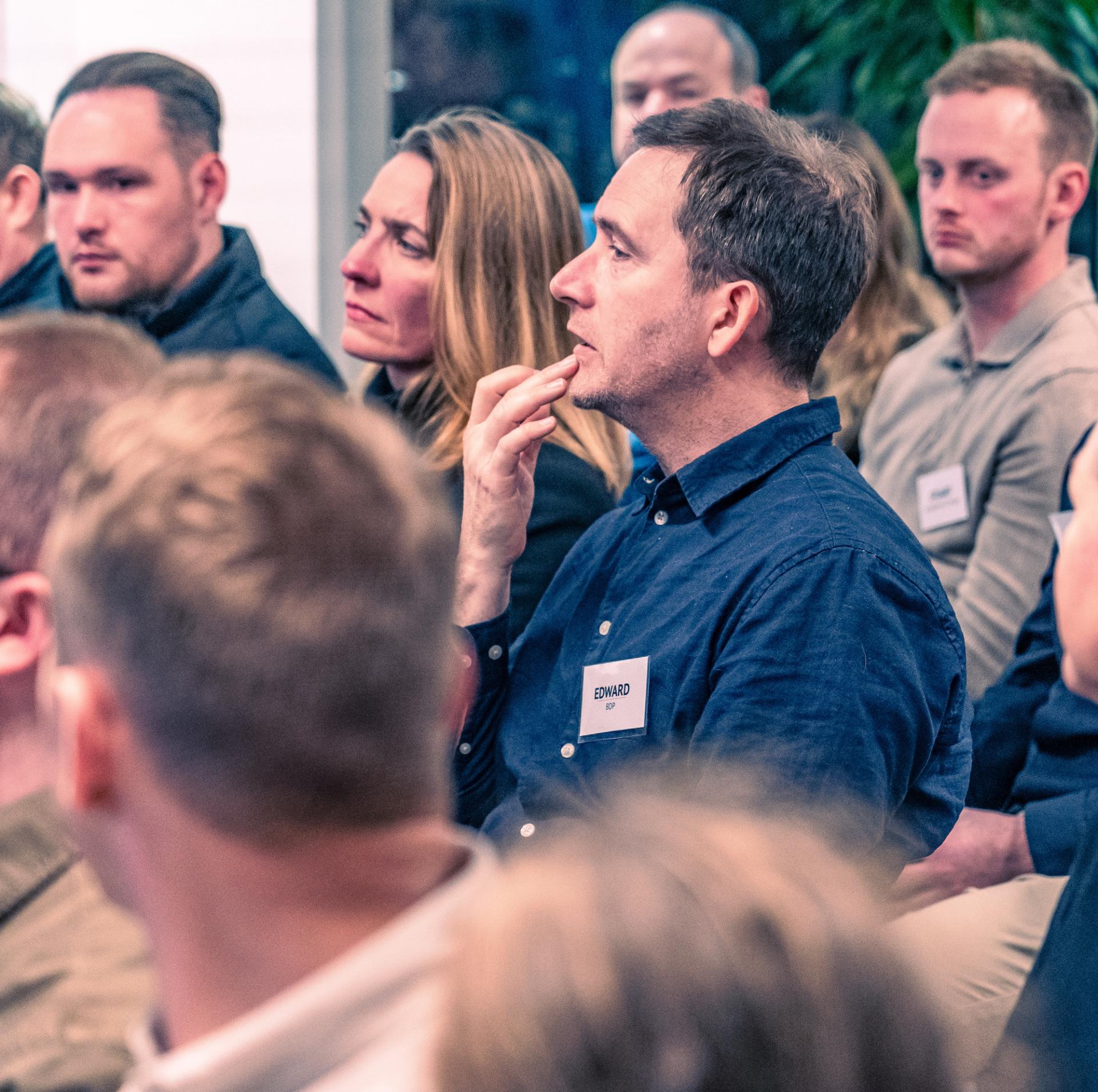 Attendees engaged in discussion during a seminar on Net Zero Carbon Buildings, focusing on sustainability in architecture.