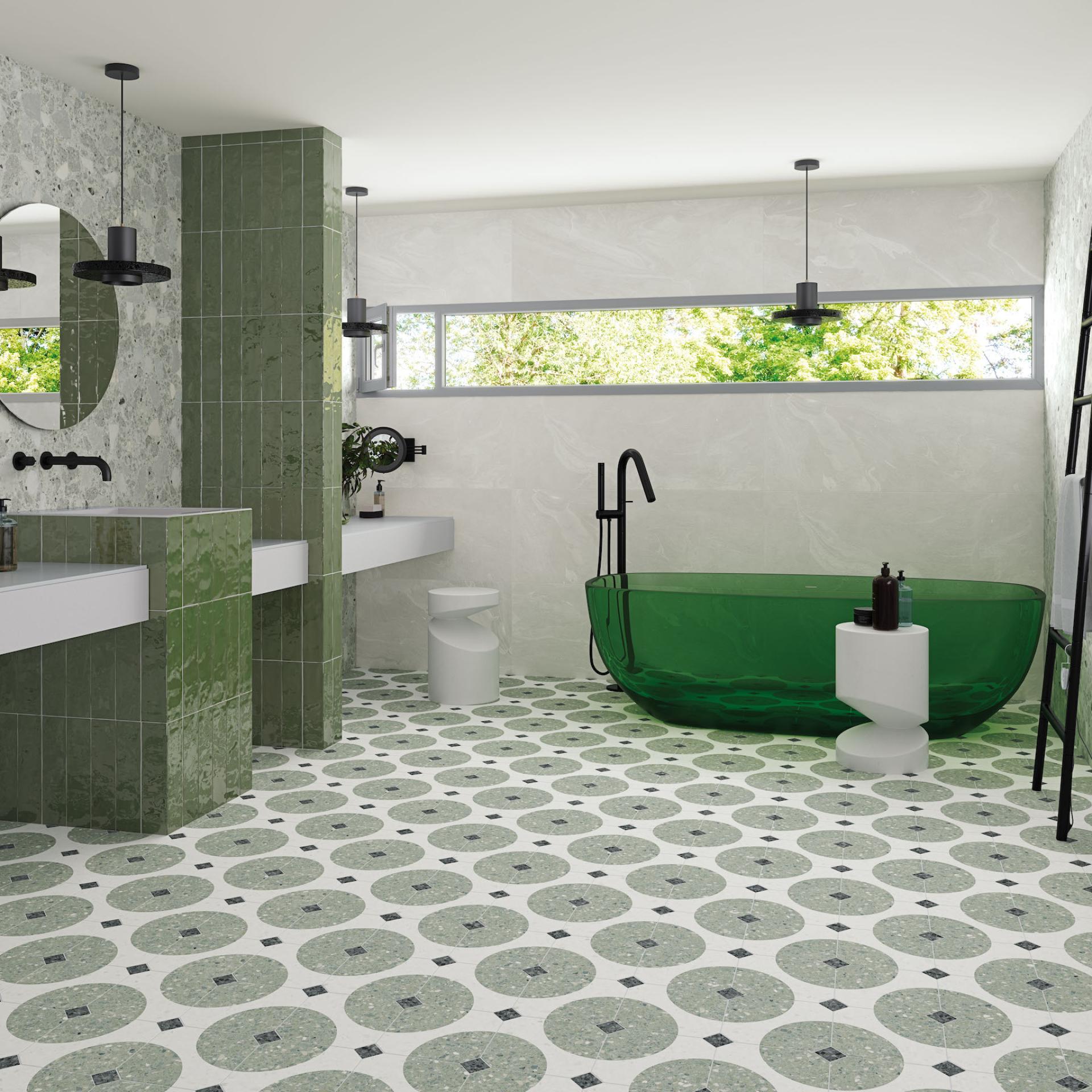 Stylish bathroom featuring green tile accents, a modern freestanding tub, and a patterned floor inspired by Spanish tile trends.