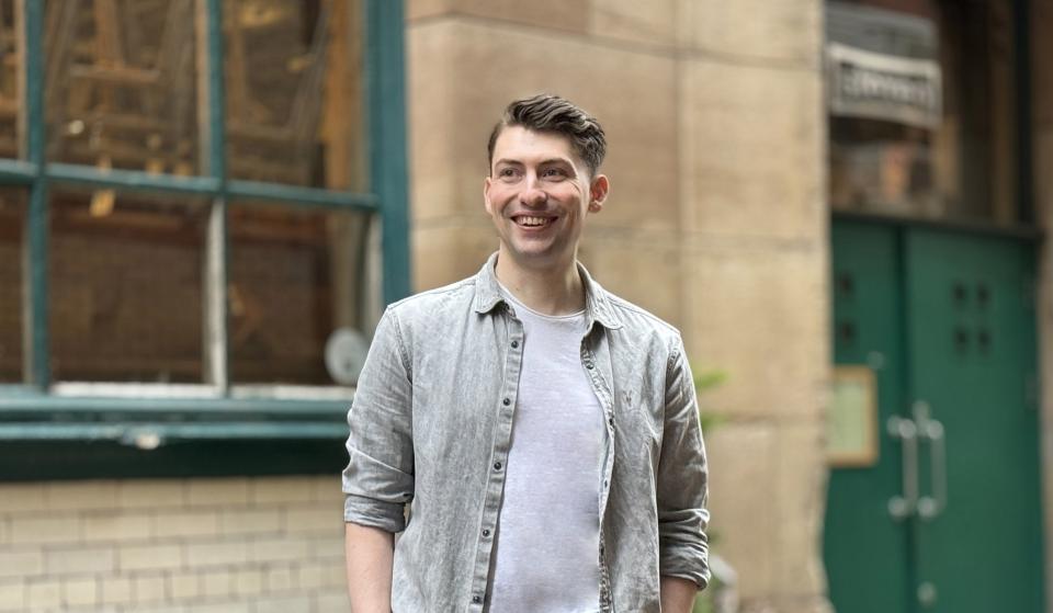 Keelan Roebuck - a man stood in front of a building smiling