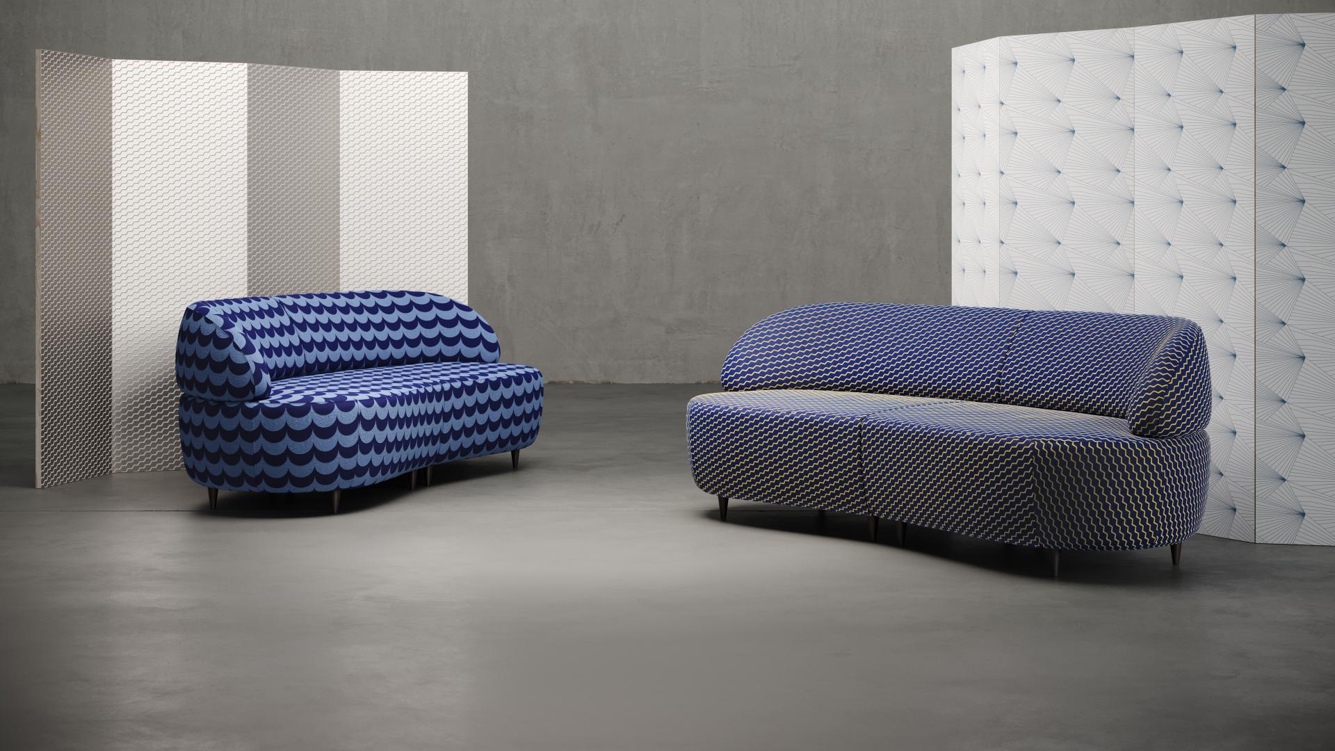 Modern Flock collaboration features stylish blue sofas designed by Erica Wakerly, showcased with textured wallpaper in a contemporary setting.