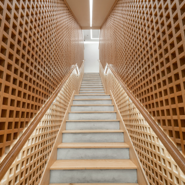 Modern staircase featuring a wooden lattice wall design, embodying the Japandi aesthetic in Brew92's new coffee shop interior.