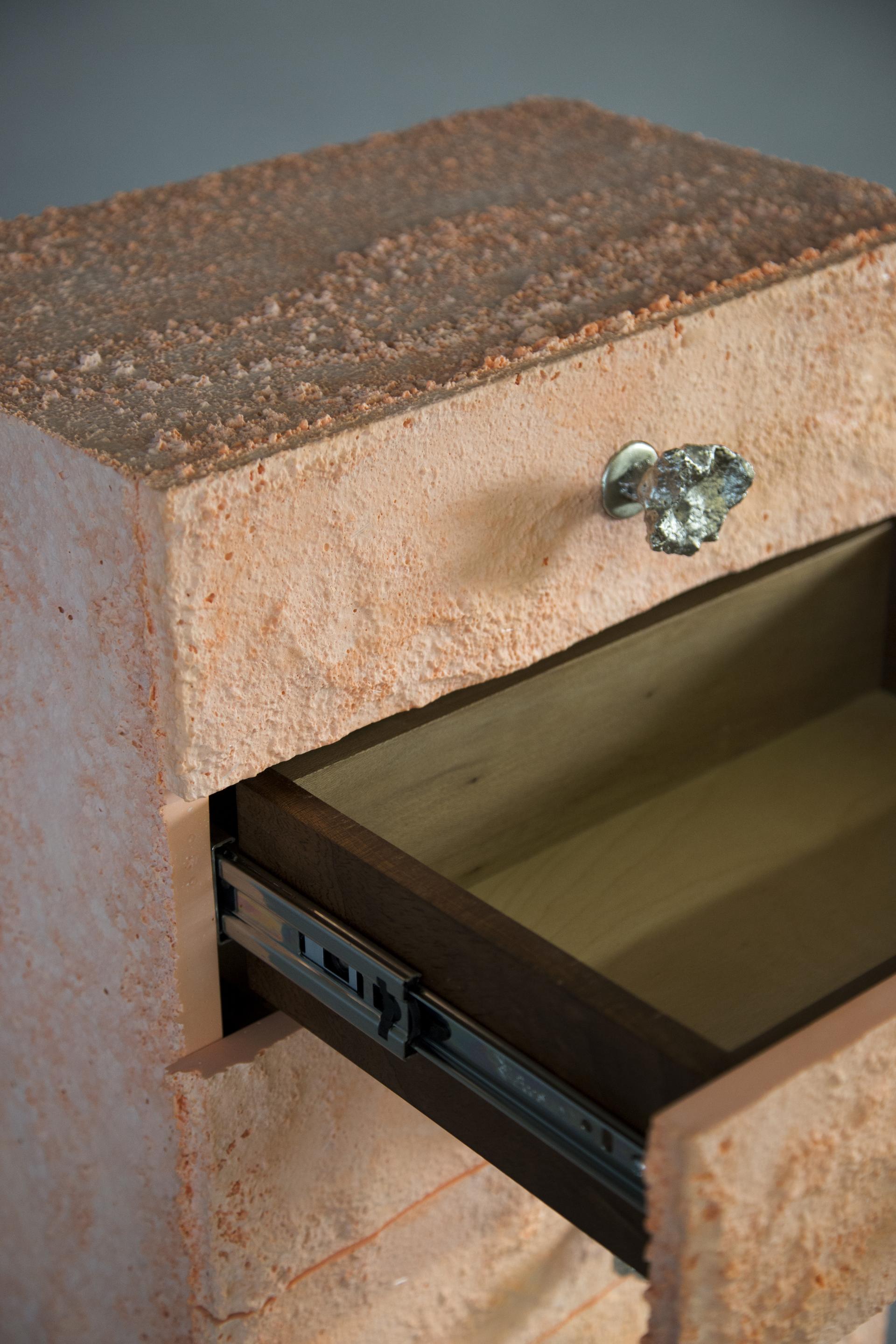 Textured furniture piece by Gavin Stanley Keightley, showcasing design inspired by natural erosion, featuring a unique drawer handle.