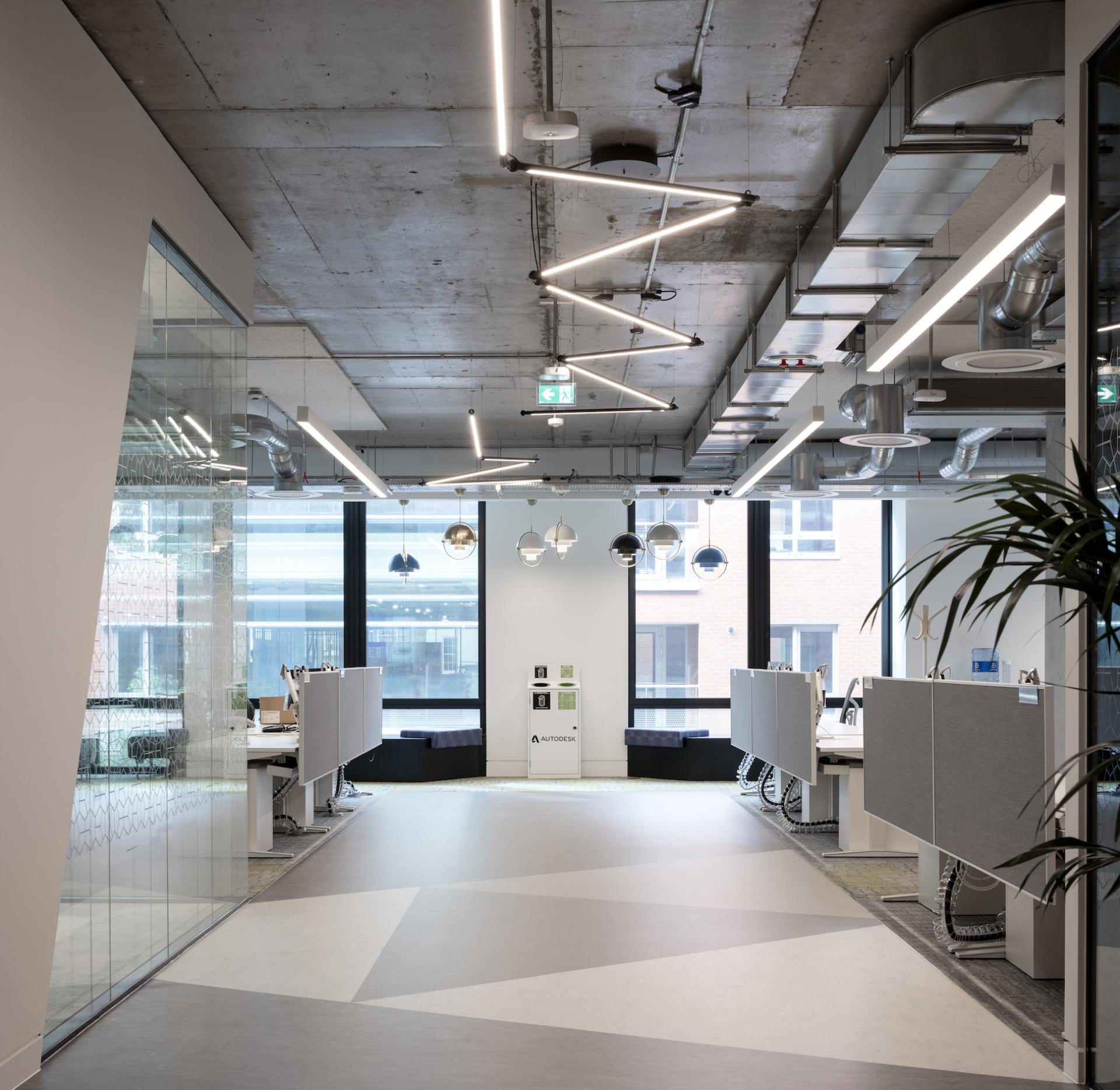 Modern office interior at Autodesk Dublin headquarters featuring stylish Martinelli Luce lighting and open workspace design.