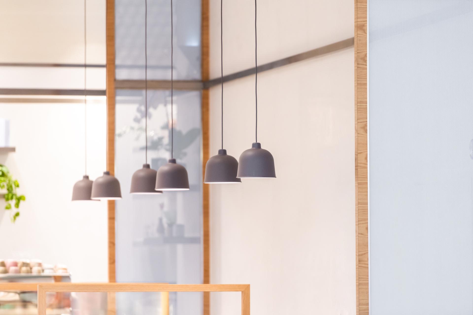 Modern pendant lighting in a handcrafted dessert shop, enhancing the contemporary design aesthetic of H2R's new concept.