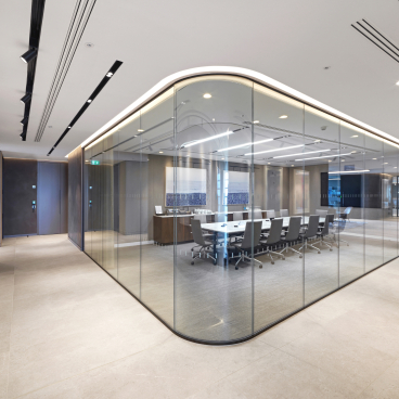 Curved glazed screens enhance Baker Botts' modern workspace, showcasing premium partitioning and elegant design elements.