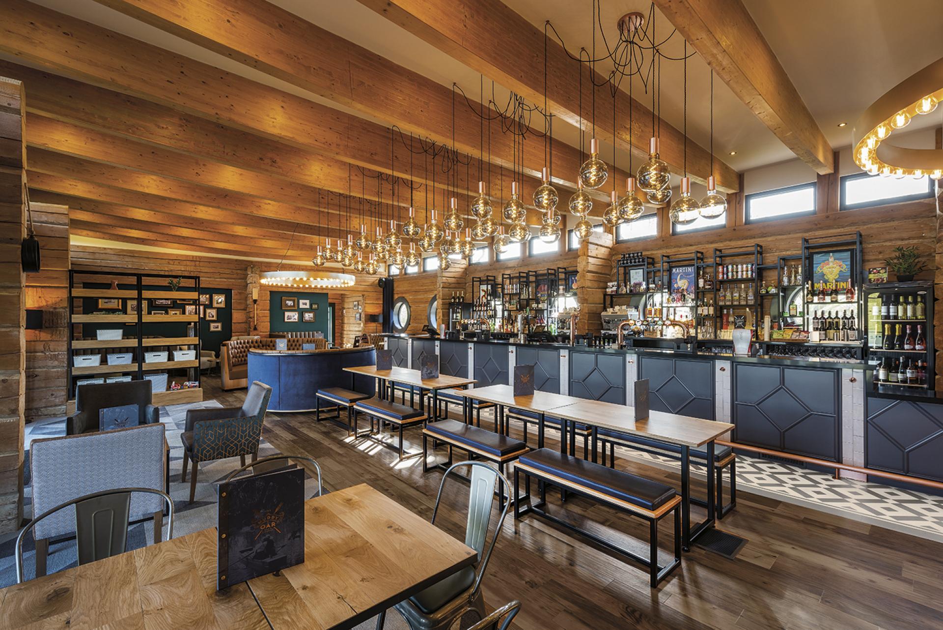 Refurbished bar area of The Muddy Oar in Stratford-Upon-Avon featuring a nautical design with wooden beams and pendant lighting.