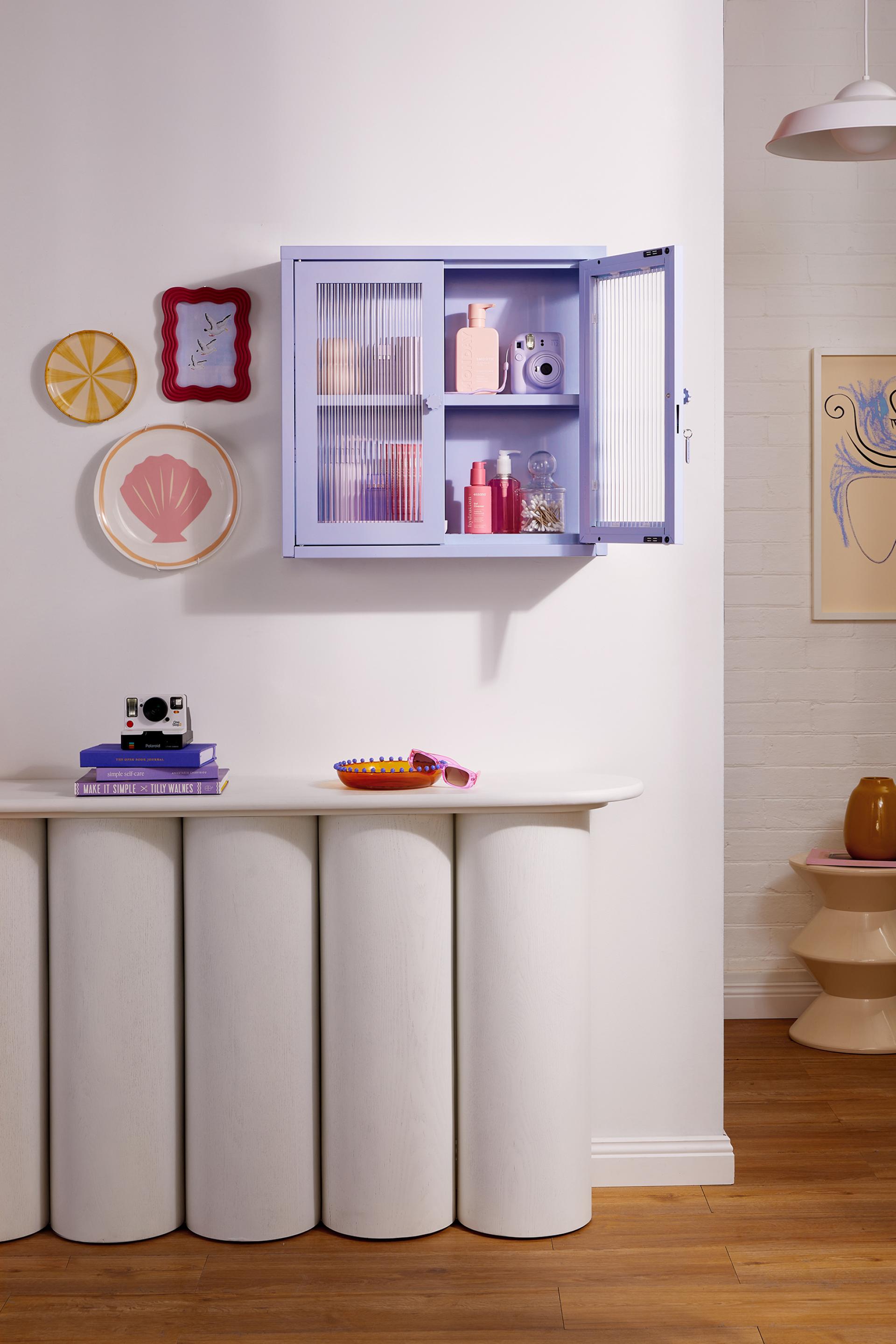 Colorful Mustard Made Glass Collection cabinet with decorative items and playful home decor accents on display.