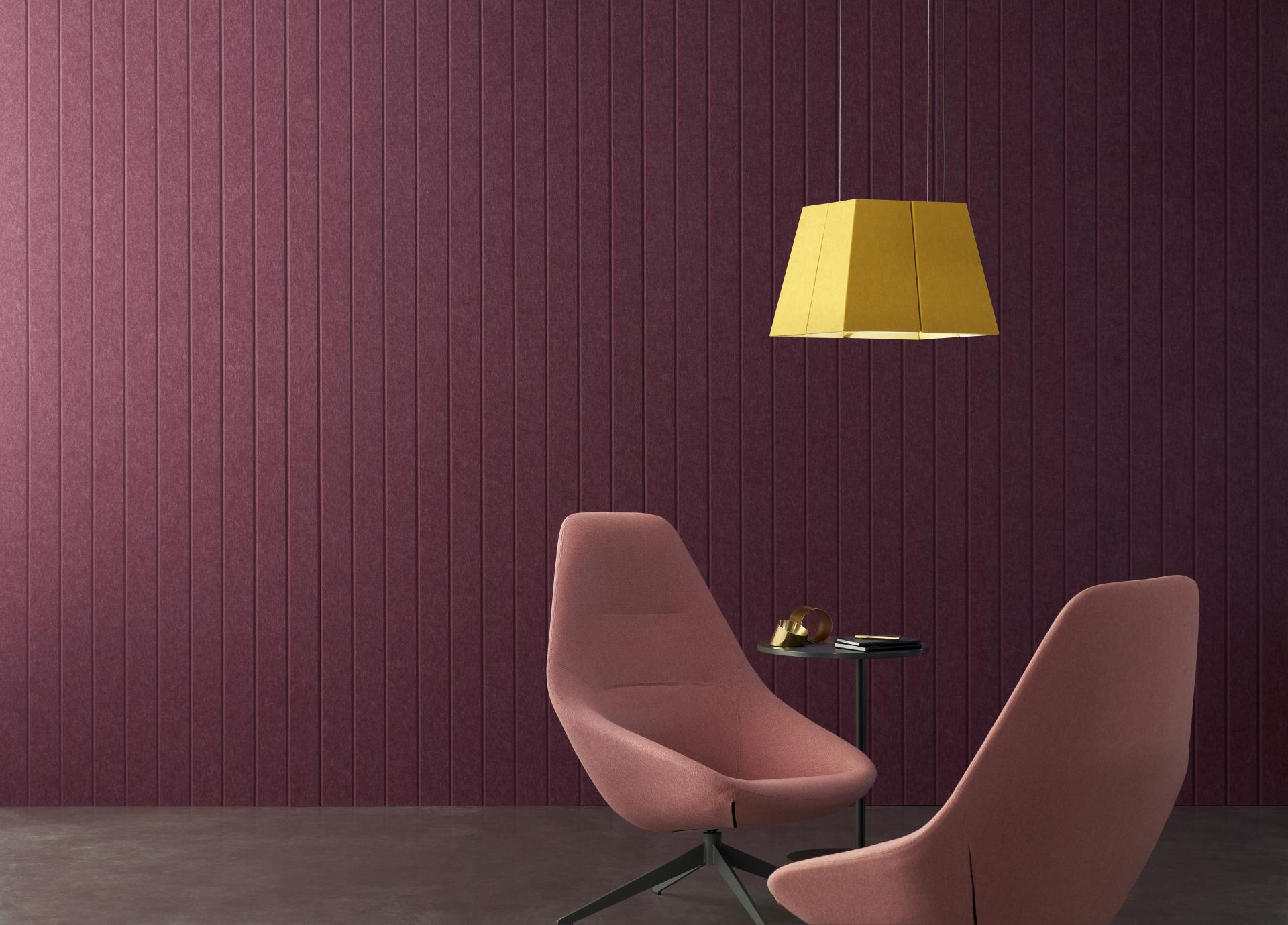 Stylish interior featuring EchoPanel® wall in deep plum, modern chairs, and a geometric yellow lamp, enhancing acoustic design.