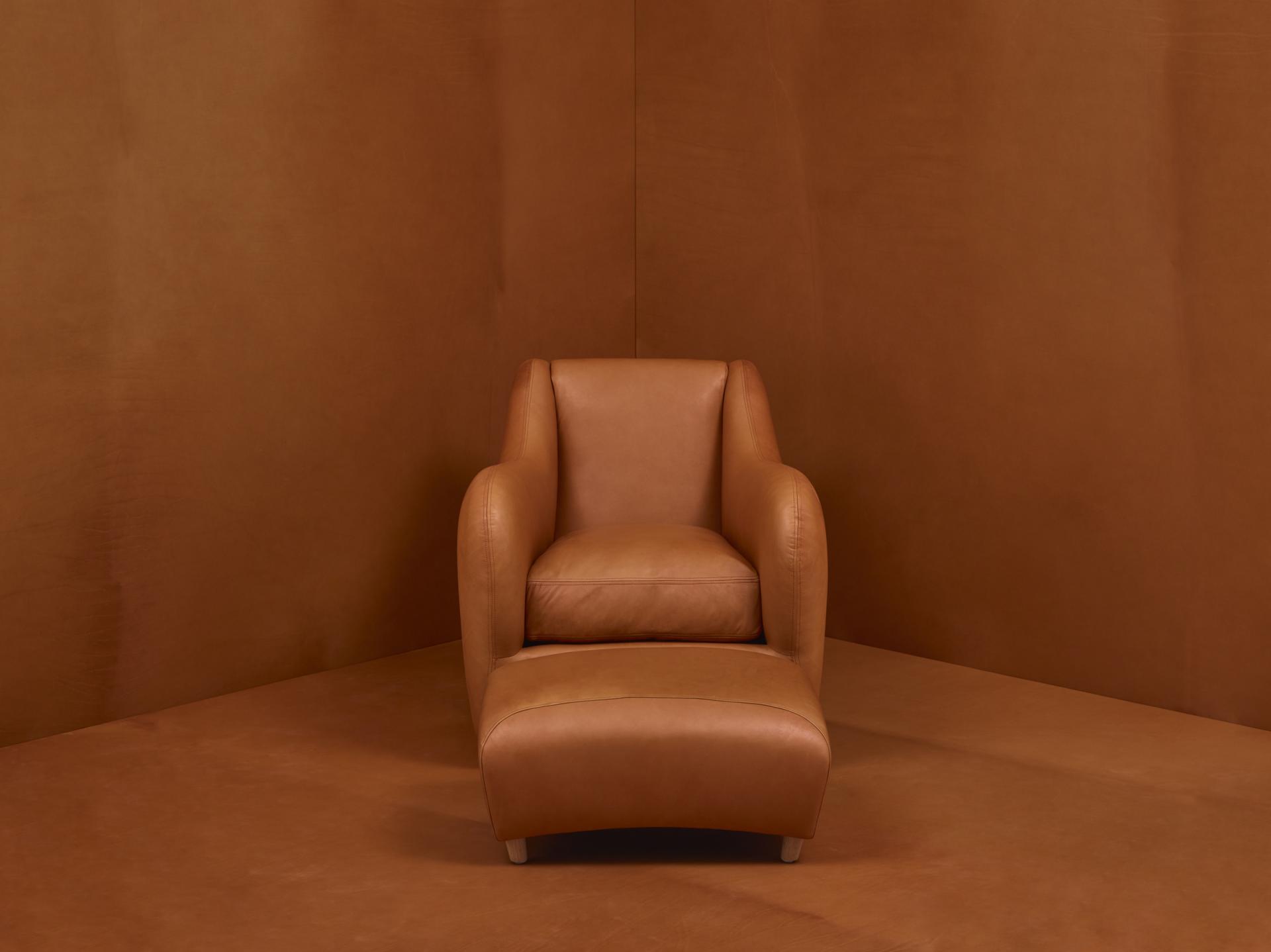 Matthew Hilton's Balzac armchair in tan leather, showcasing a timeless design celebrating thirty years of production.