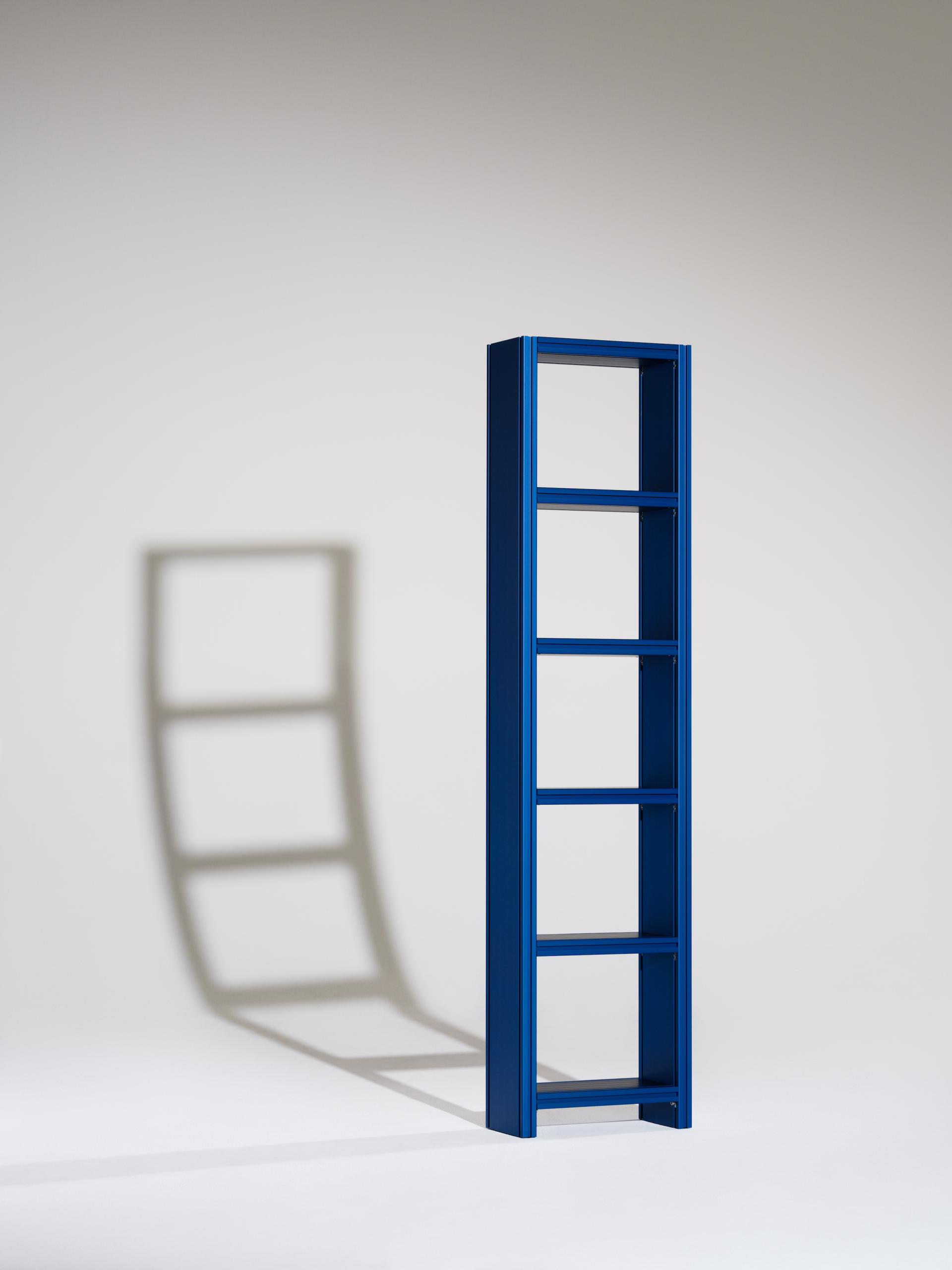 A tall, blue bookshelf showcasing a modern design, emphasizing sustainable materials for the Material Matters Fair.