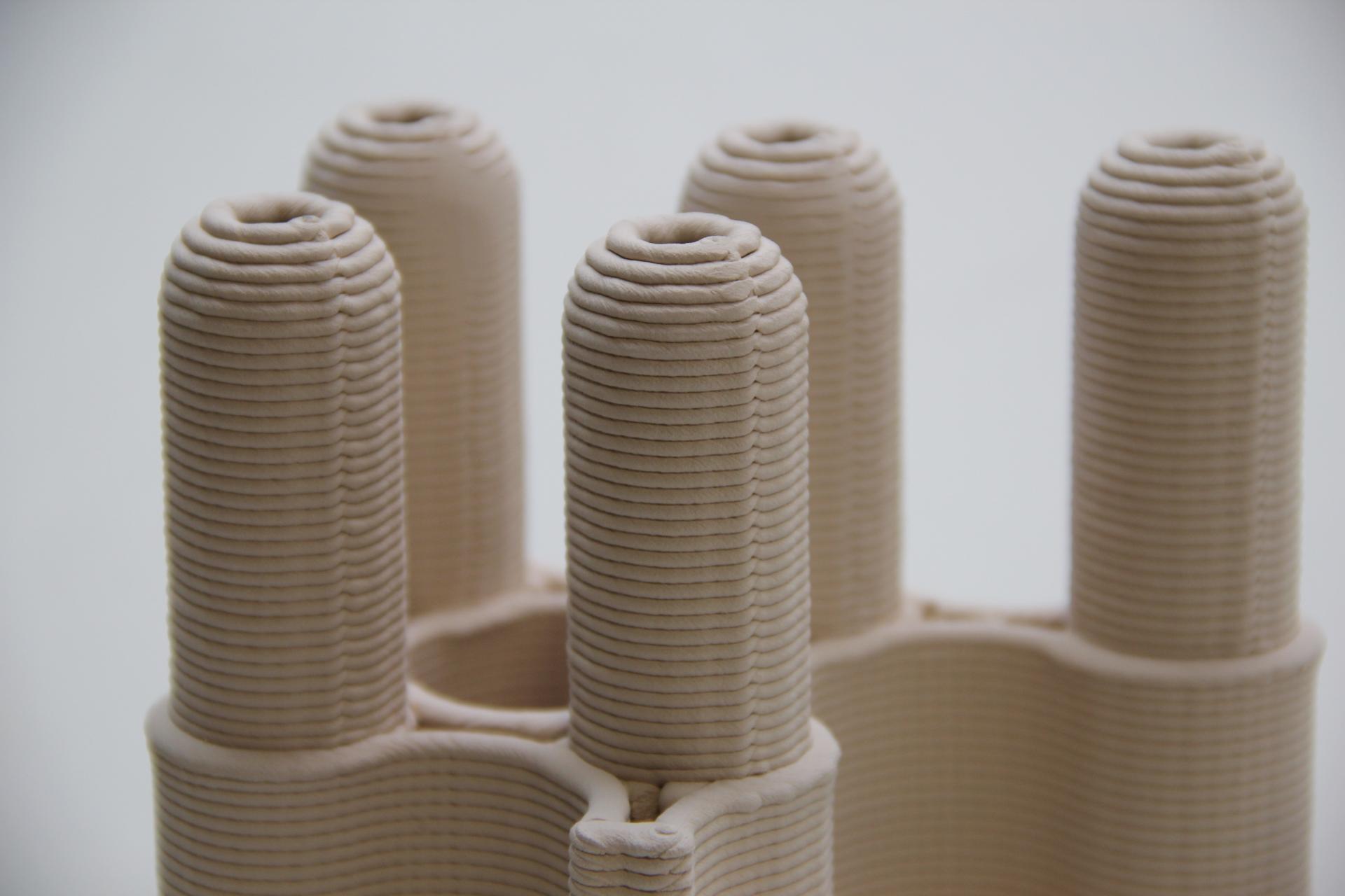 Close-up of a 3D printed construction structure, showcasing intricate layering and design for innovative building solutions.