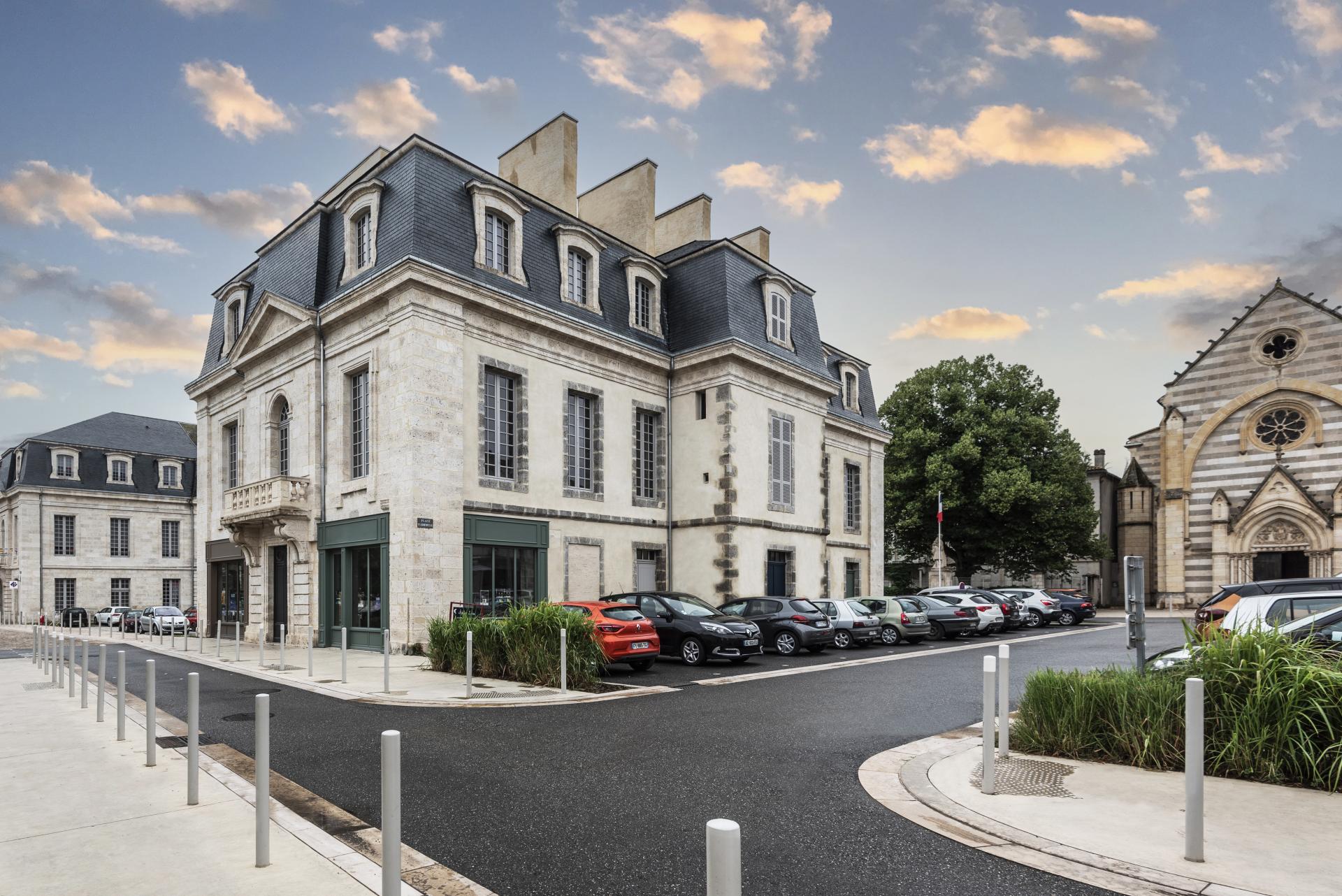 Architectural details of a historic building in Europe, showcasing beautiful design and surrounding greenery.