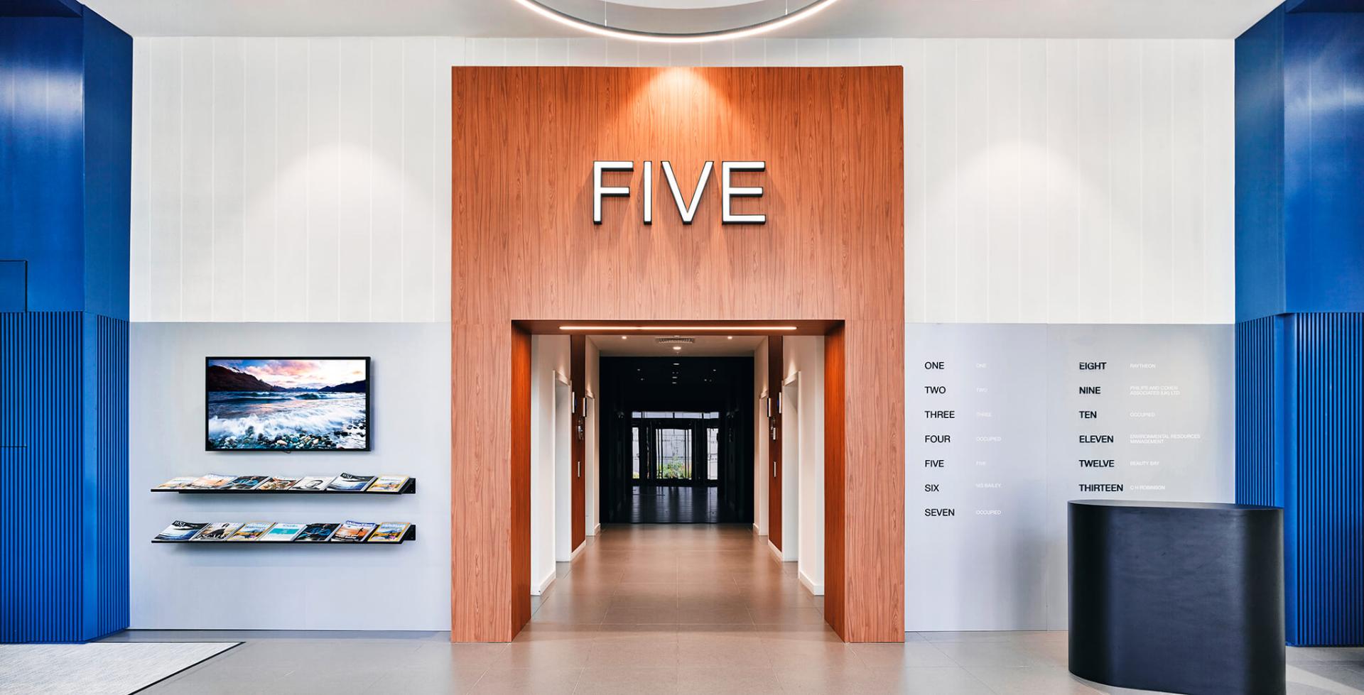 Modern entryway showcasing the number "FIVE," emphasizing sustainable and thoughtful design in a stylish environment.