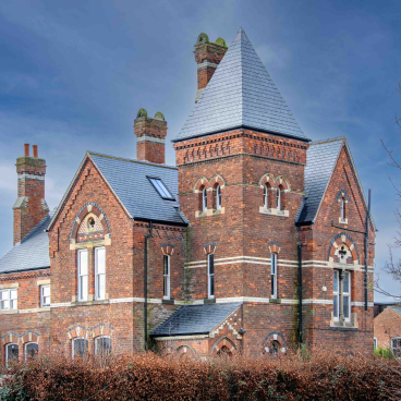 Victorian Gothic-style Heworth House with natural slate roof, showcasing 19th-century architectural revival.
