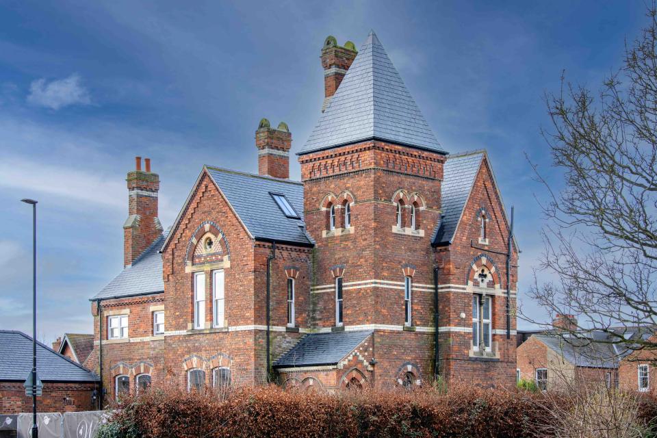 Victorian Gothic-style Heworth House with natural slate roof, showcasing 19th-century architectural revival.
