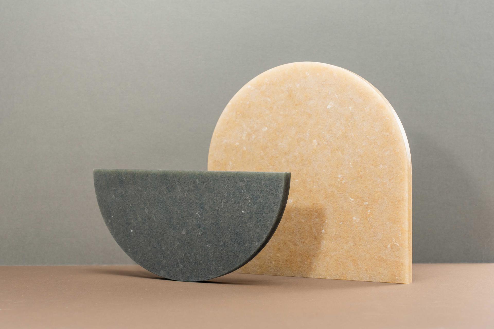 Natural-colored semi-circular pieces representing Smile Plastics’ Earth Collection, showcasing textures inspired by the Welsh landscape.