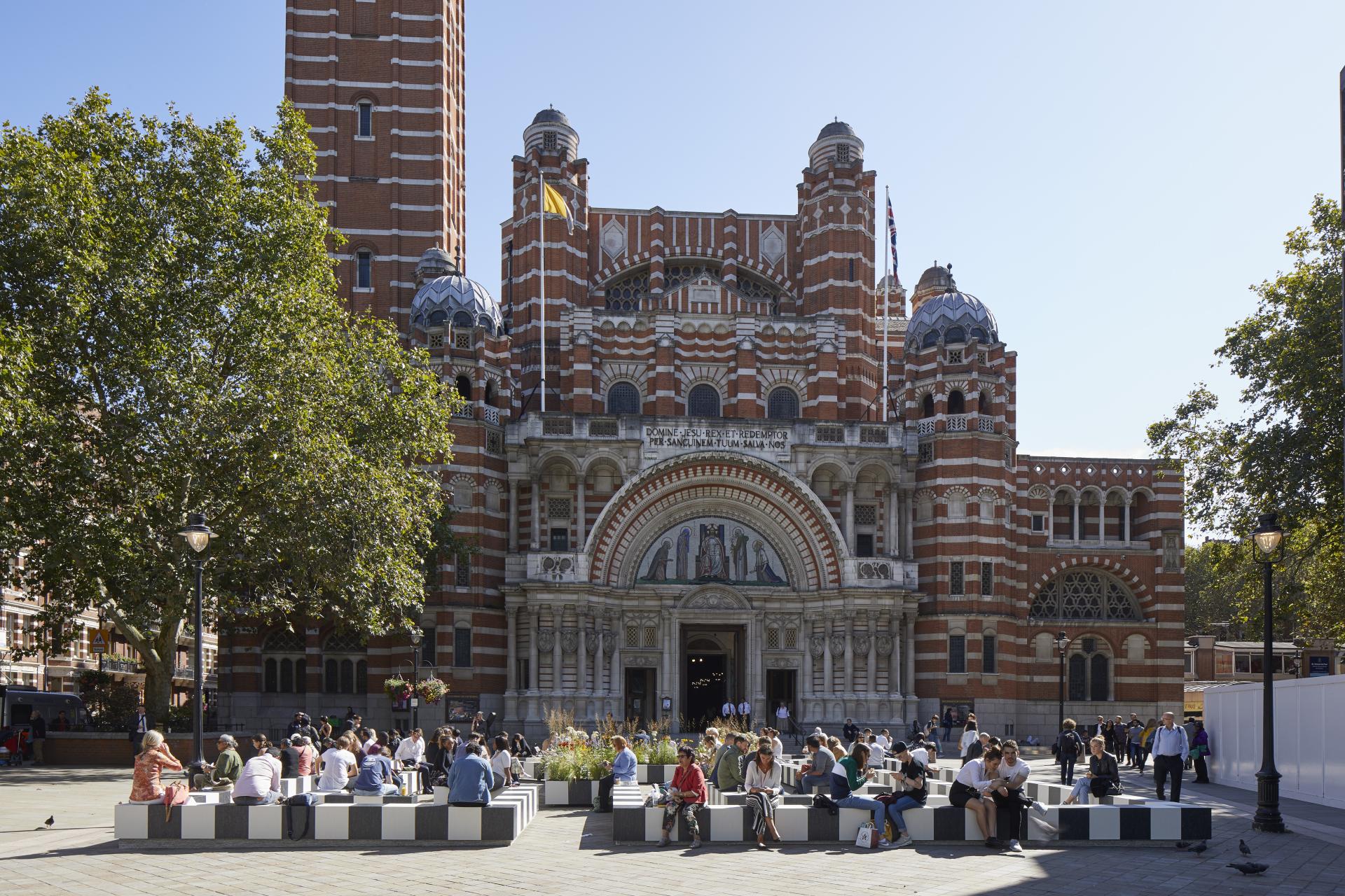 Visitors gather in the square near the ornate architecture of Westminster Cathedral during the London Design Festival.
