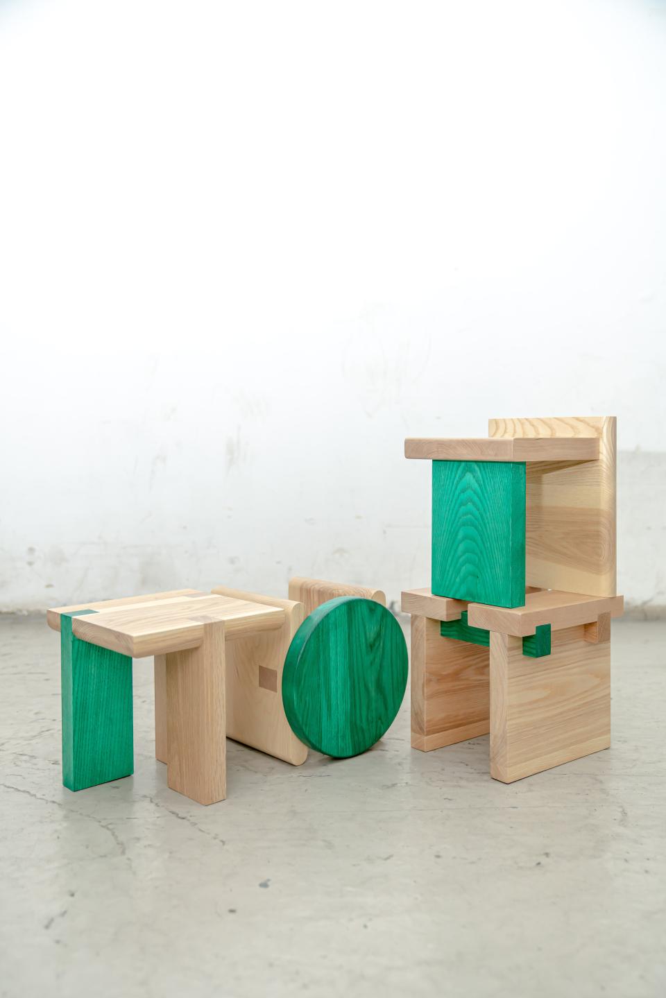 Colorful mini-stools arranged creatively, showcasing their versatile design and unique craftsmanship, ideal for modern decor.