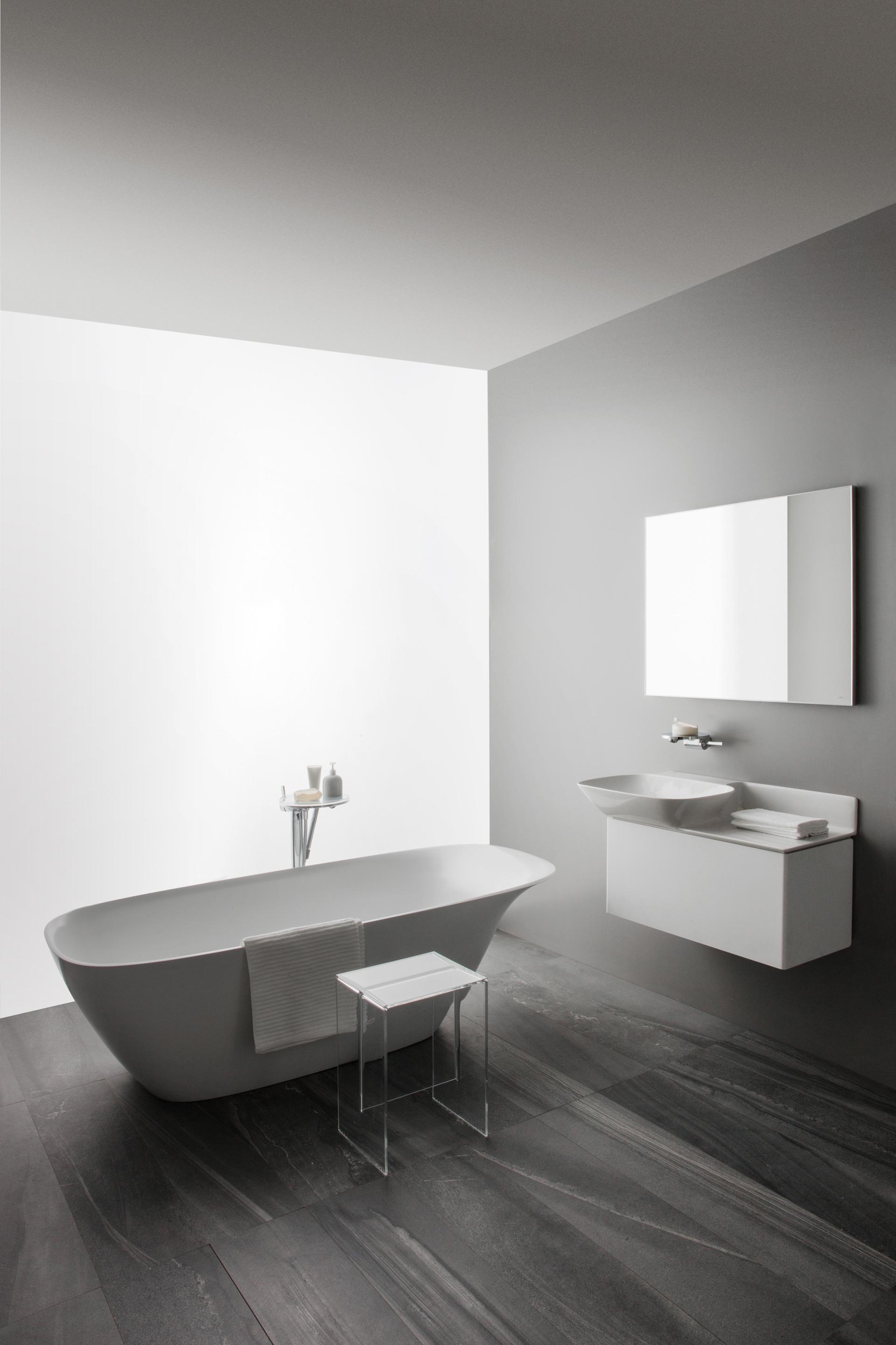 Modern LAUFEN bathroom featuring a sleek freestanding bathtub, minimalist fixtures, and elegant gray tile flooring.