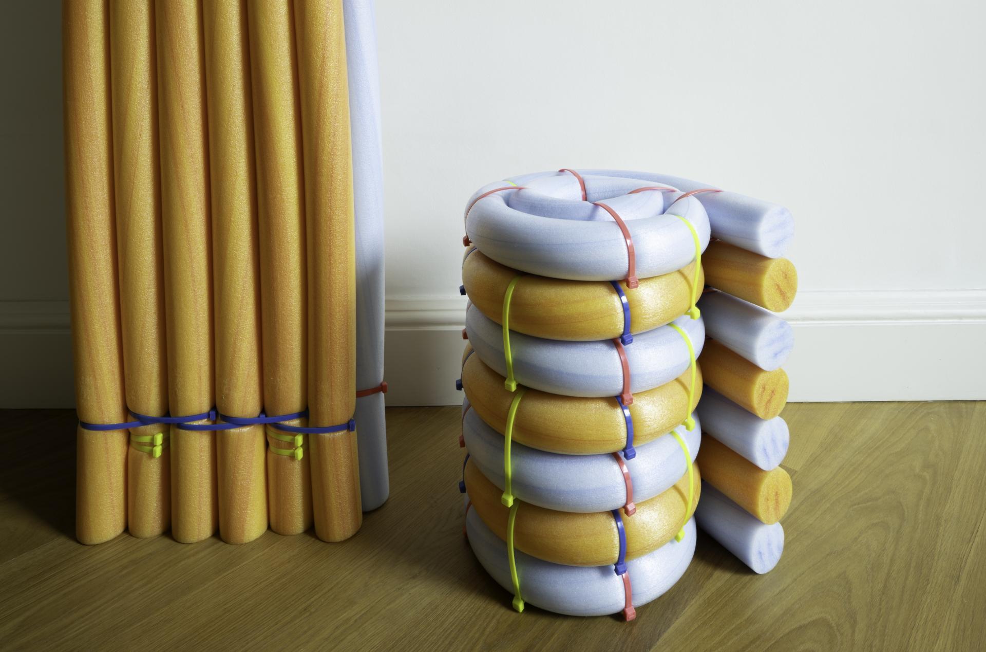 Colorful, stacked foam tubes and poles used in innovative design at Dundee Design Festival 2024 exhibition.