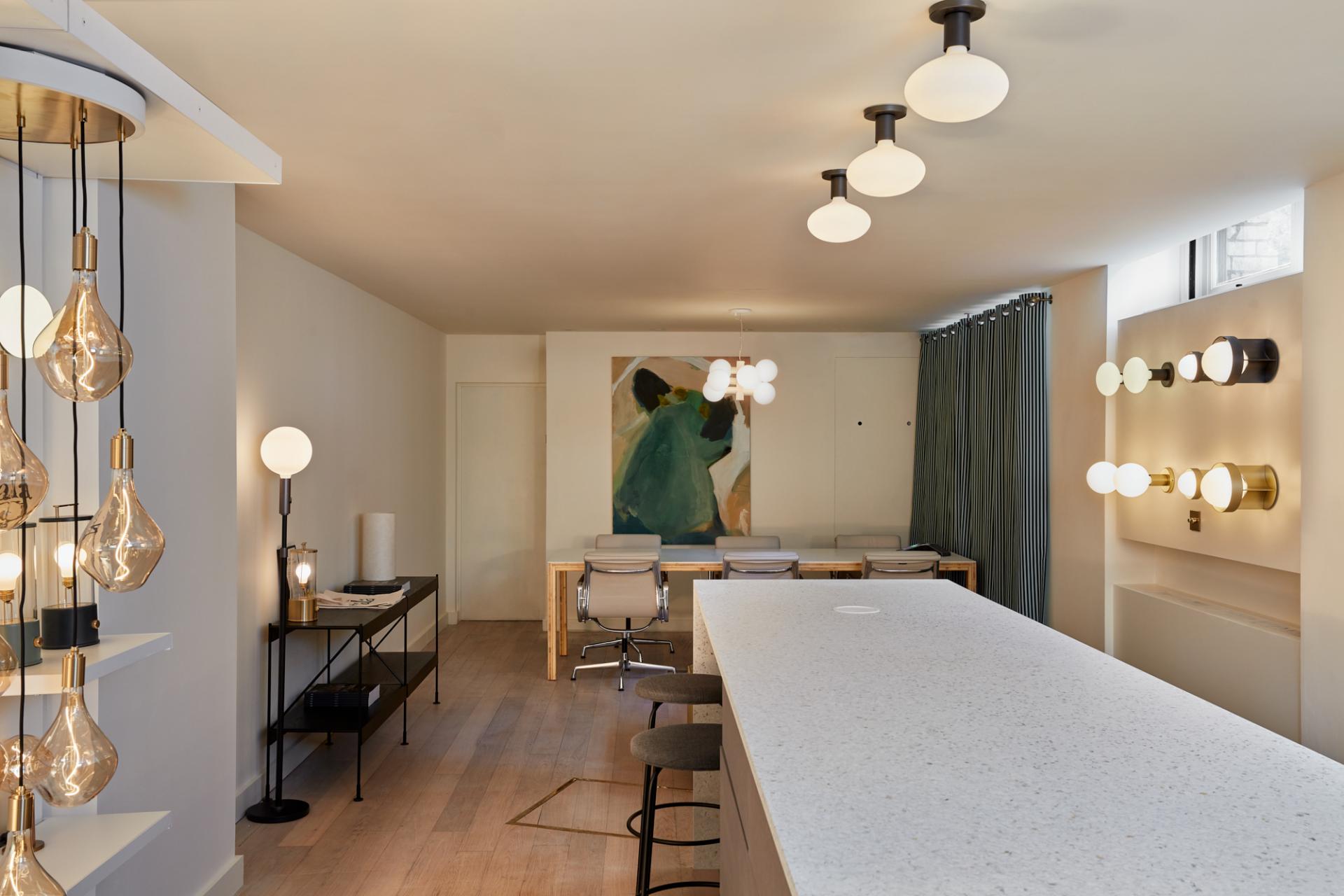 Modern Shoreditch showroom featuring Tala's sustainable lighting designs, with a minimalist aesthetic and artistic decor.