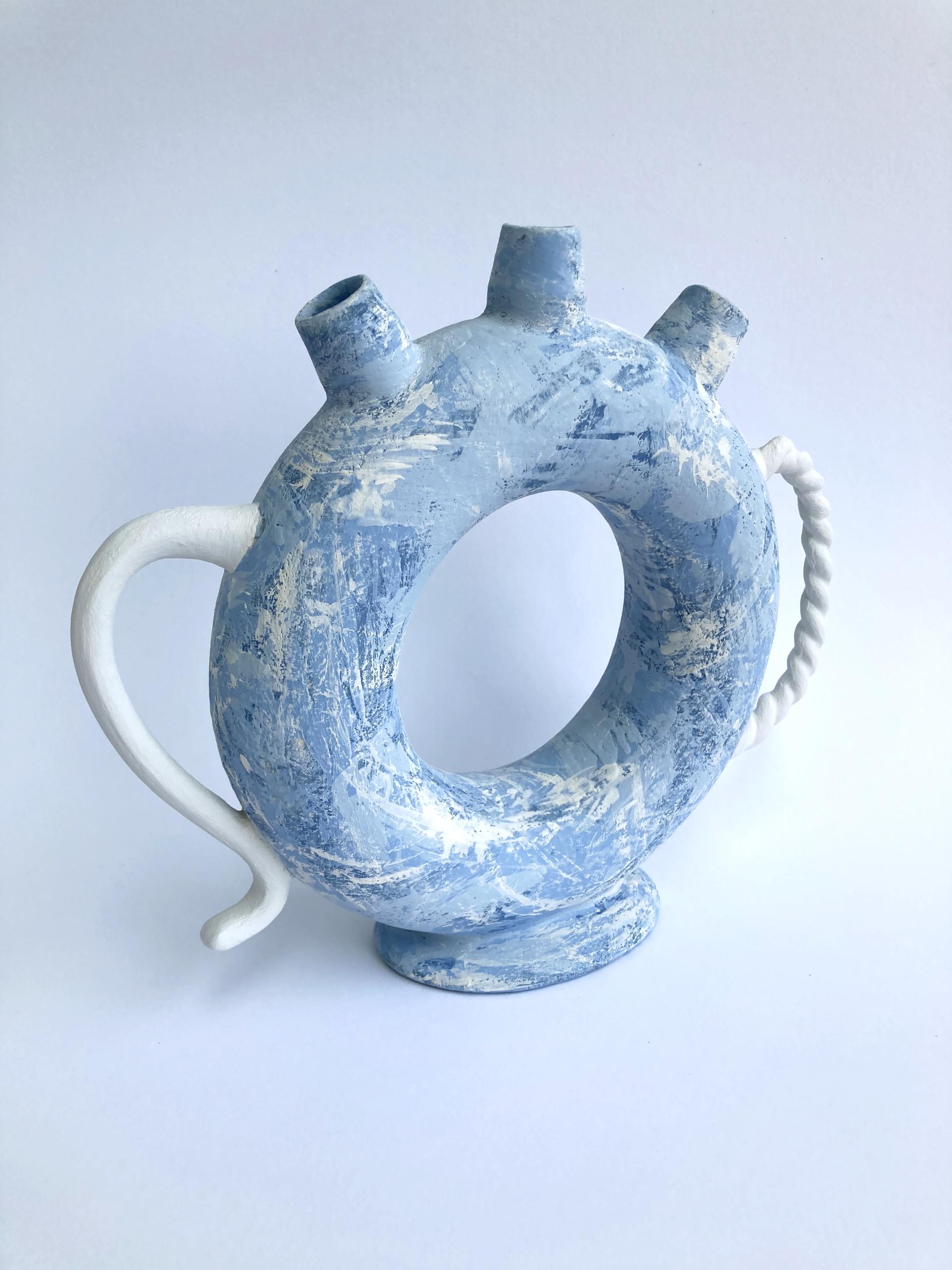 Ceramic vase by Jo Woffinden, featuring a unique blue finish and sculptural handle design, showcased at Harewood House Biennial.