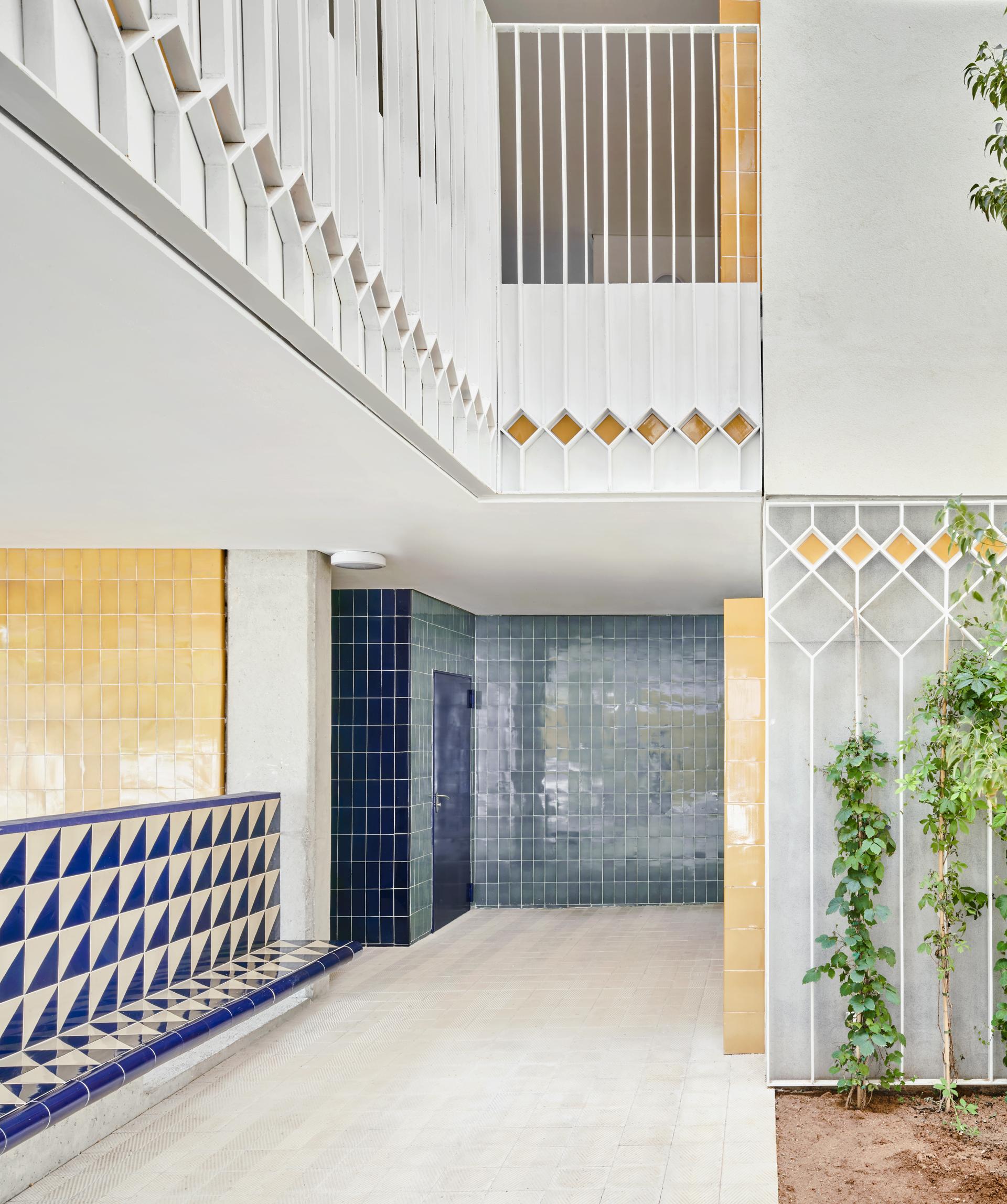 Stylish architectural interior featuring vibrant ceramic tiles in blue, yellow, and geometric patterns, highlighting innovative design.