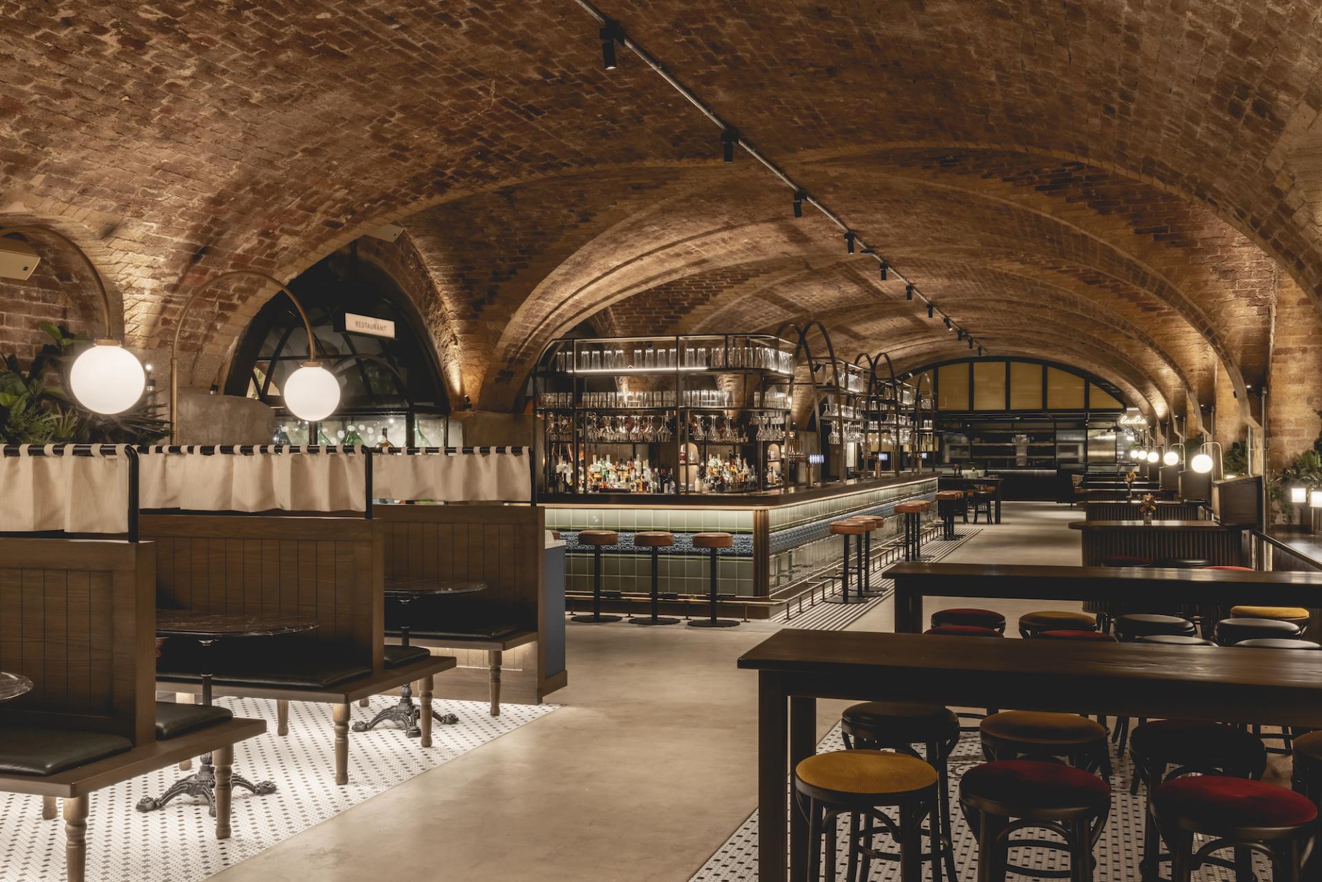 Elegant interior of The Libertine at the Royal Exchange, featuring a stylish bar and modern seating in a historic setting.