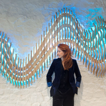 Art installation by Frankie Boyle featuring a wooden wall piece with blue lighting, evoking emotions at LiGHT 24 exhibition.