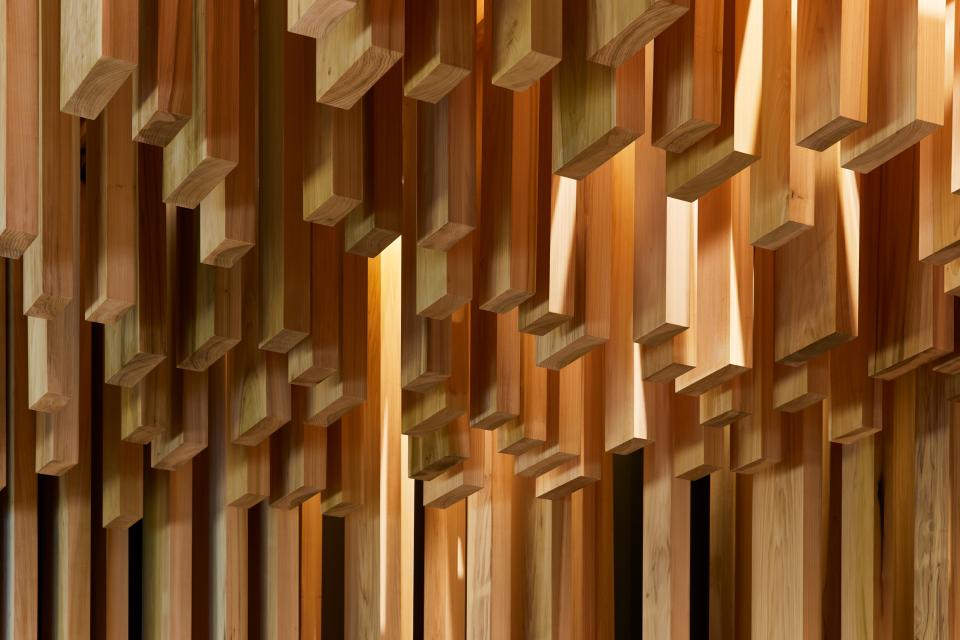 Intricate arrangement of American tulipwood panels, showcasing the architectural design by David Adjaye at the Design Museum.