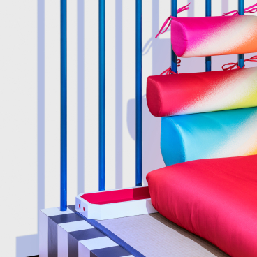 Vibrant Memphis-inspired furniture featuring colorful textiles and unique geometric design, showcasing the essence of Night Tales by Masanori Umeda.