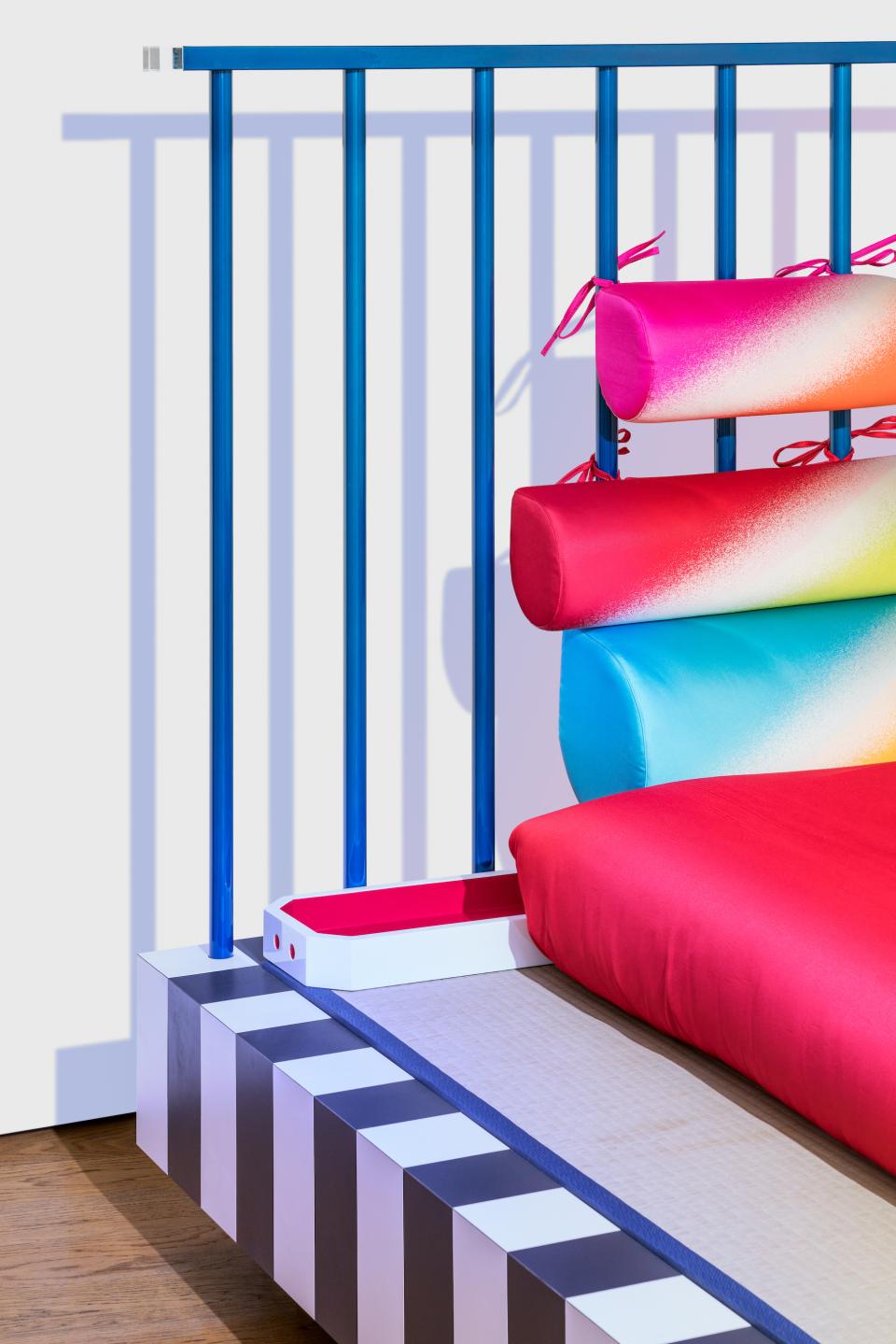 Vibrant Memphis-inspired furniture featuring colorful textiles and unique geometric design, showcasing the essence of Night Tales by Masanori Umeda.