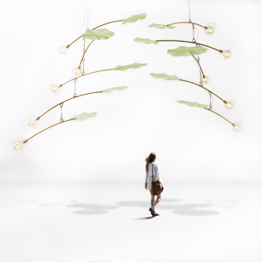 Elegant hanging light fixtures designed by Kenneth Cobonpue, showcasing modern art-inspired shapes with natural elements and warm illumination.