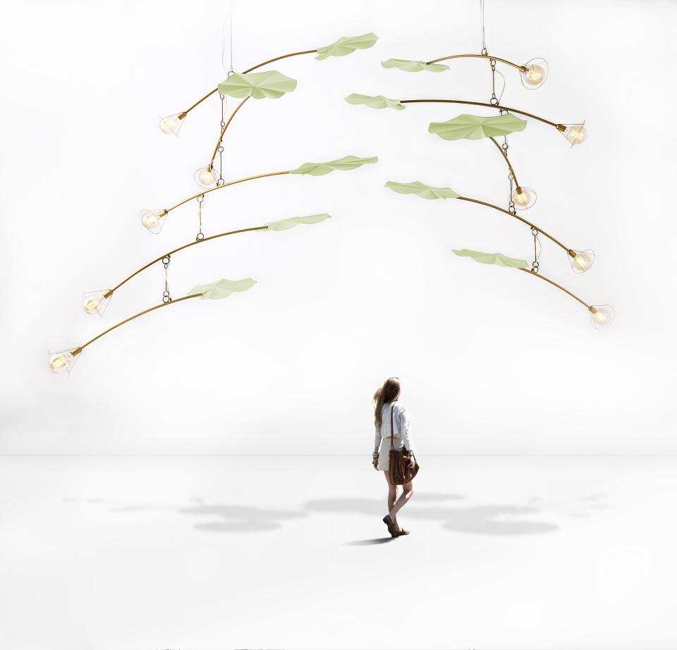 Elegant hanging light fixtures designed by Kenneth Cobonpue, showcasing modern art-inspired shapes with natural elements and warm illumination.