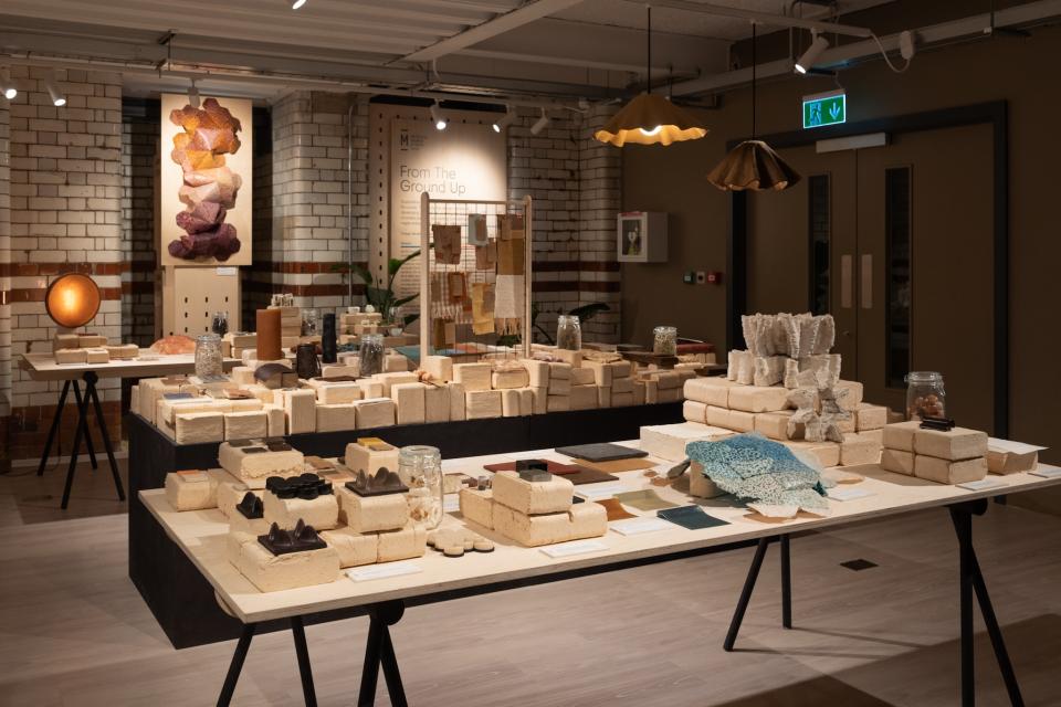 Exhibition space showcasing sustainable materials and artworks at the "From The Ground Up" event, highlighting innovative design.