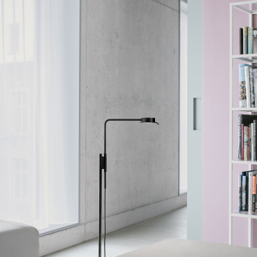 Modern w102 Chipperfield lamp by Wästberg stands elegantly in a contemporary interior with concrete walls and natural light.