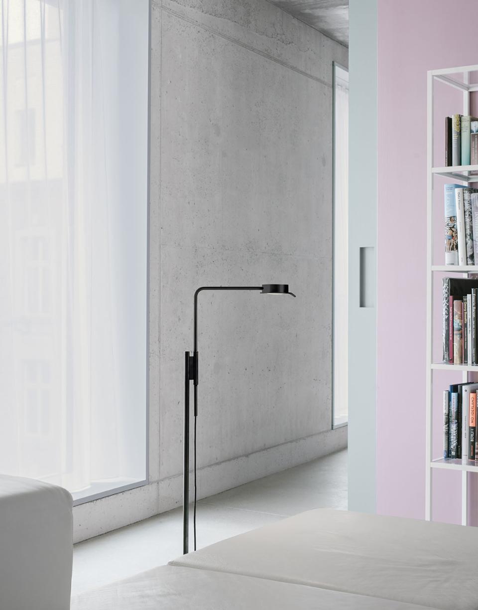 Modern w102 Chipperfield lamp by Wästberg stands elegantly in a contemporary interior with concrete walls and natural light.