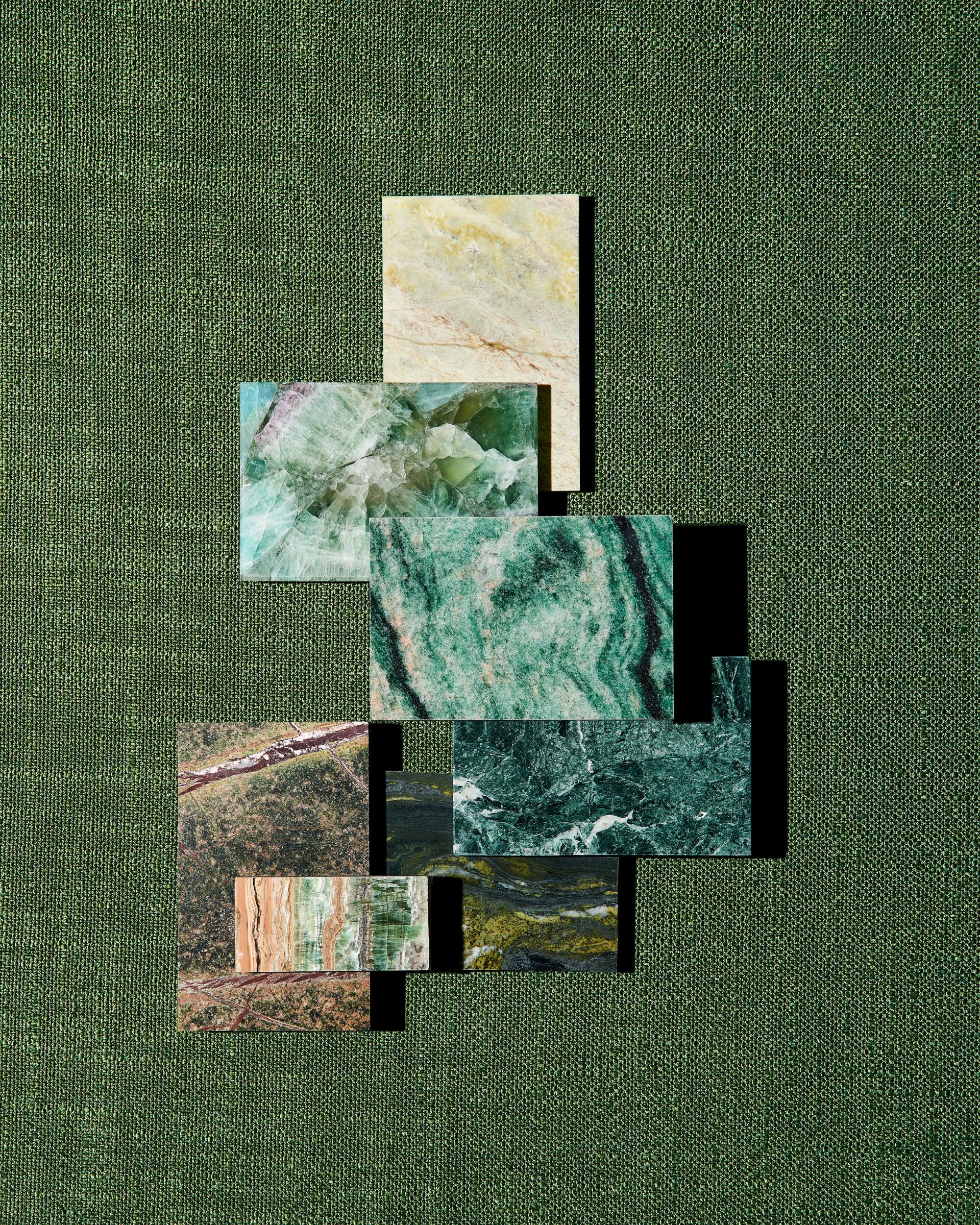Natural stone samples from SolidNature’s Green Stone Collection displayed on a textured green background, showcasing diverse colors and patterns.