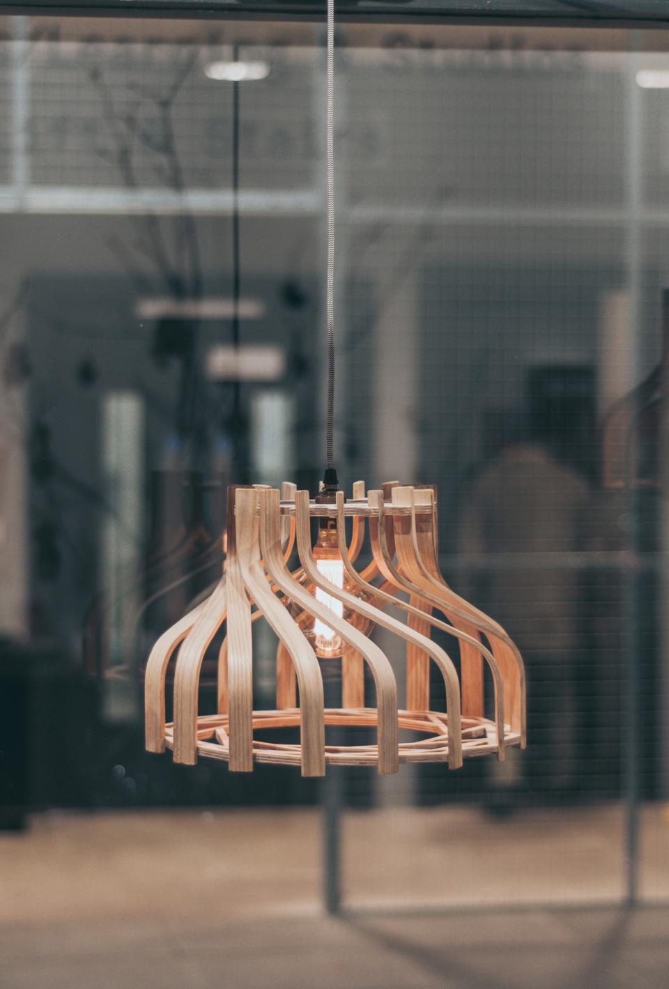 Hand-crafted wooden lampshade with an art deco design, illuminating a contemporary space inspired by Wrexham’s hippodrome.