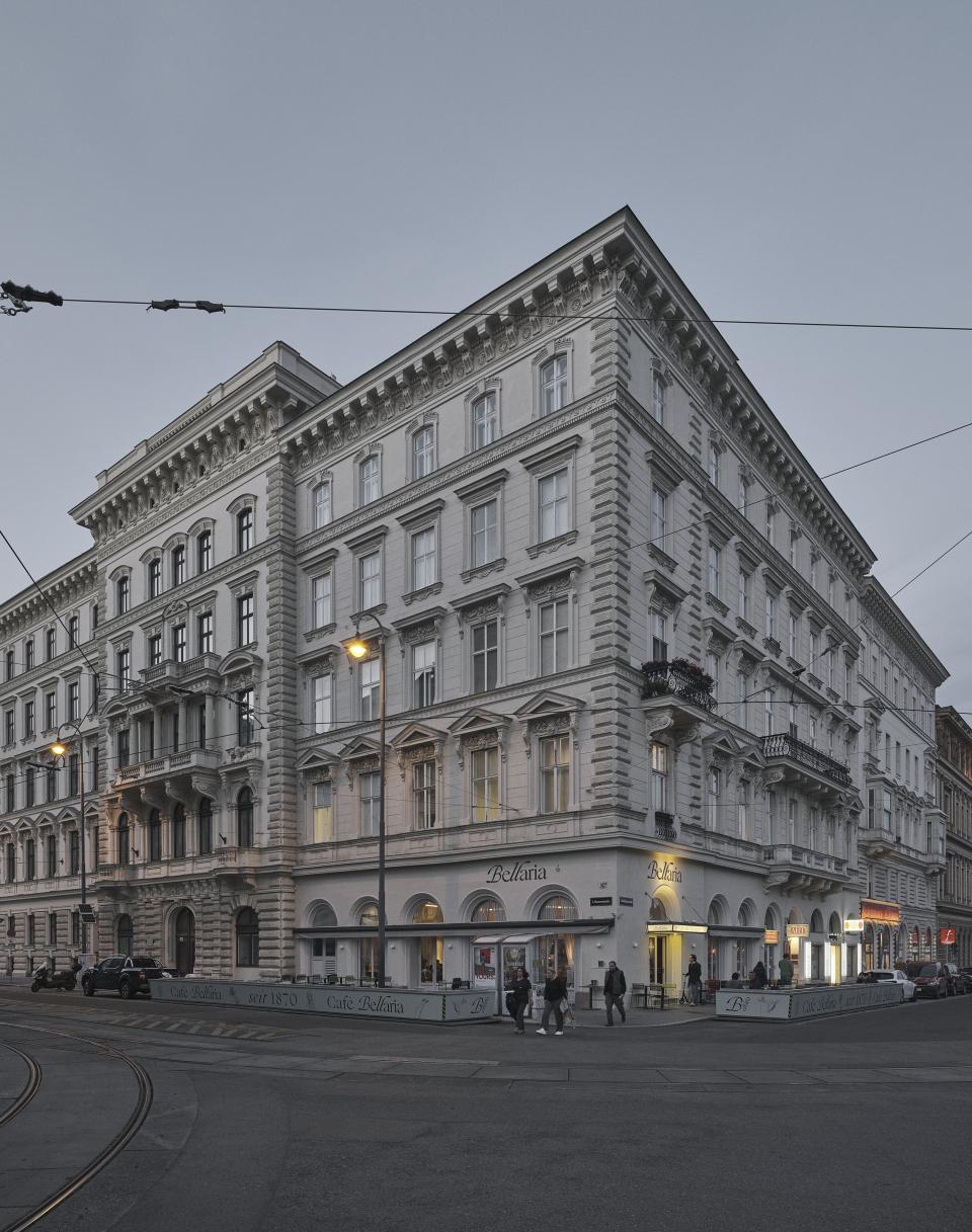 Historic Café Bellaria building in Vienna, showcasing its elegant architecture and inviting outdoor seating area for patrons.