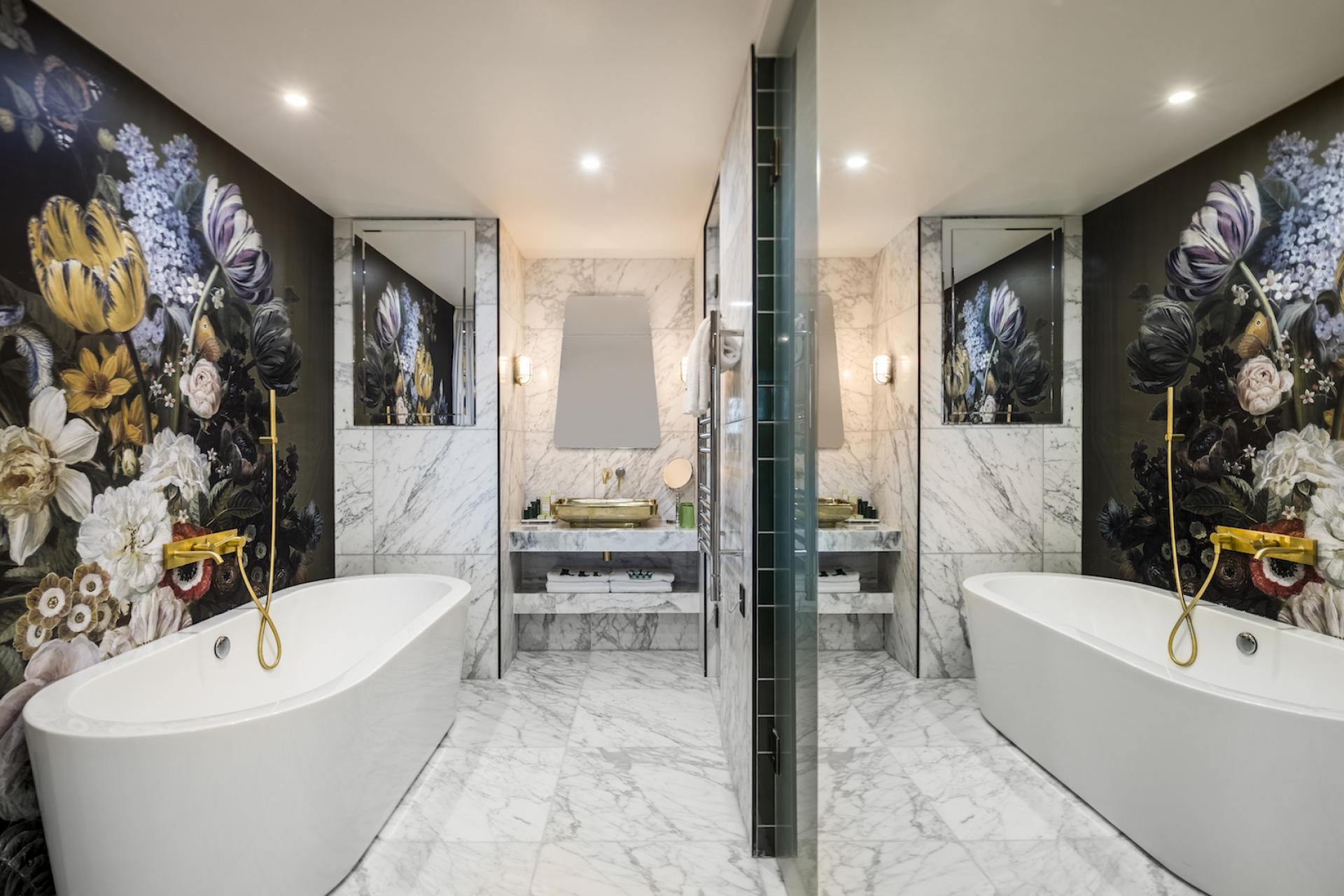 Luxurious nhow London bathroom featuring elegant marble, floral wallpaper, and modern fixtures designed by Project Orange.