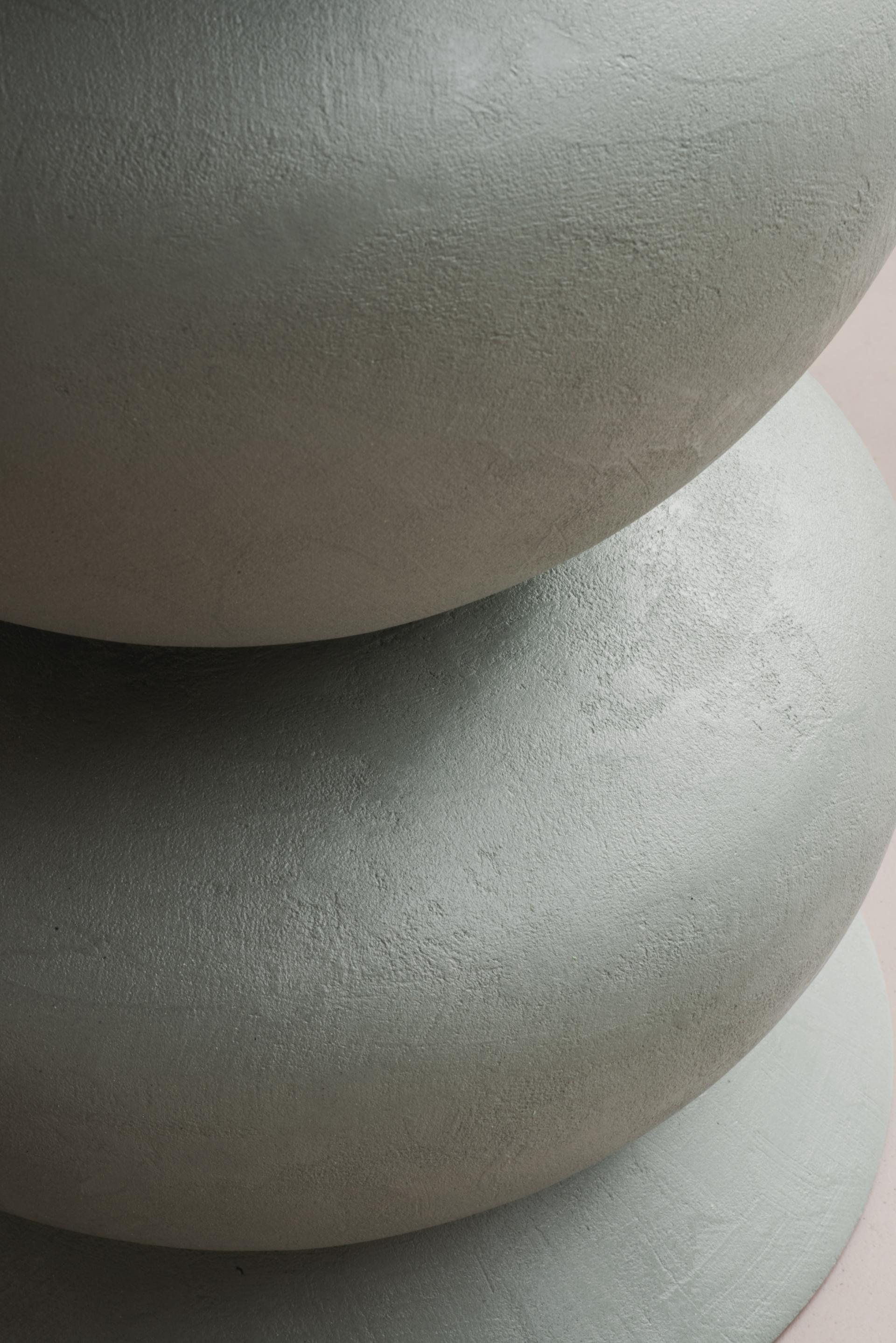 Curvaceous stools from Sella Concept's debut furniture collection, inspired by Hampstead Ladies’ Pond, showcasing a textured pastel finish.