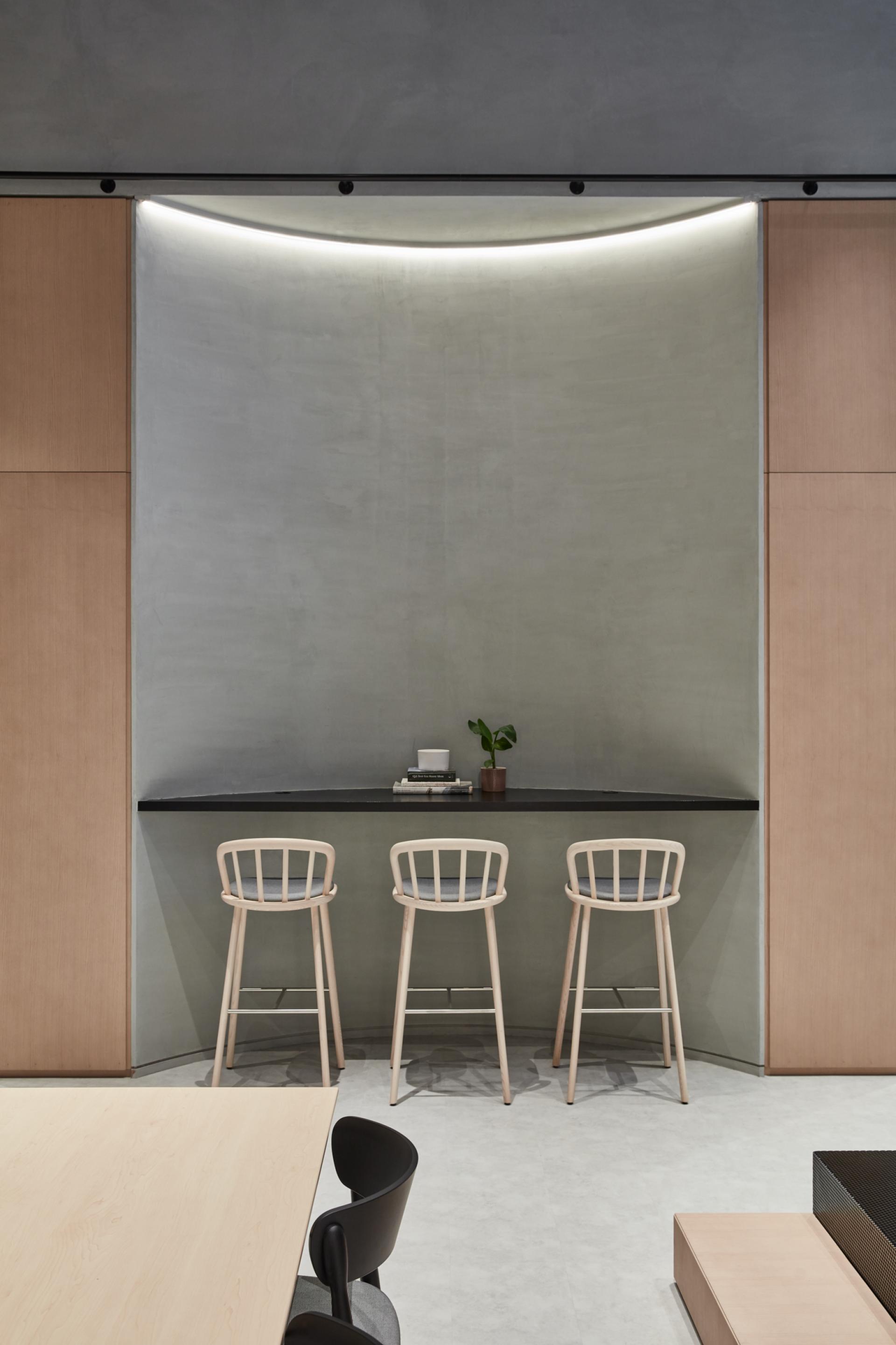 Stylish interior of Roar Studio featuring minimalist bar stools and a sleek counter in Dubai's cultural hub.