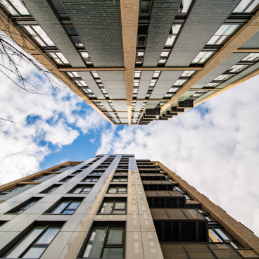 Modern residential buildings featuring Dekton façades against a blue sky in London.
