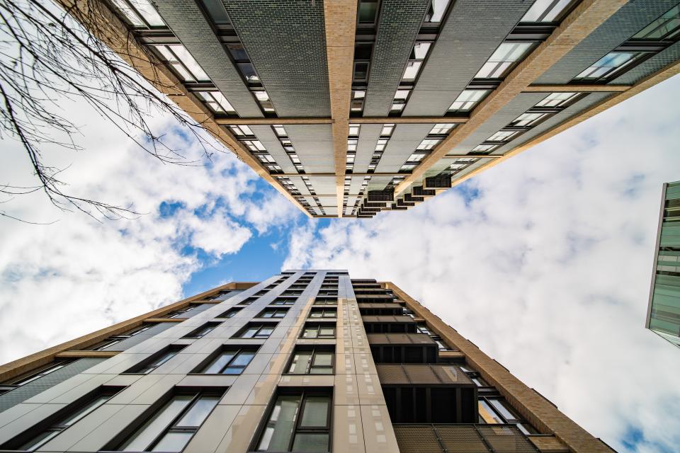 Modern residential buildings featuring Dekton façades against a blue sky in London.