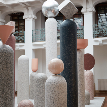 Colorful geometric sculptures and pillars displayed at Milan Design Week, showcasing Tarkett's innovative design collection.